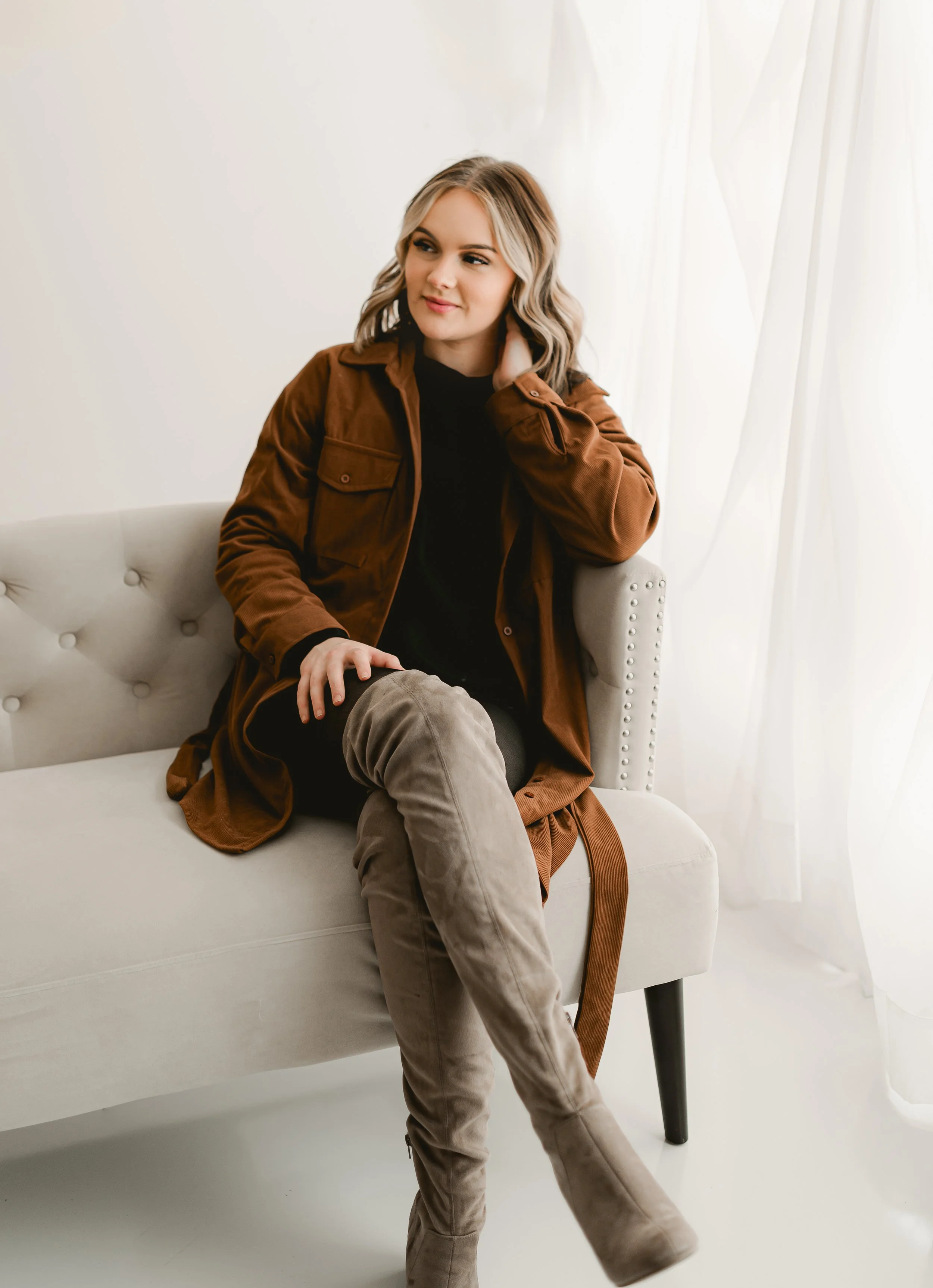 Studio headshot of a young professional looking confident