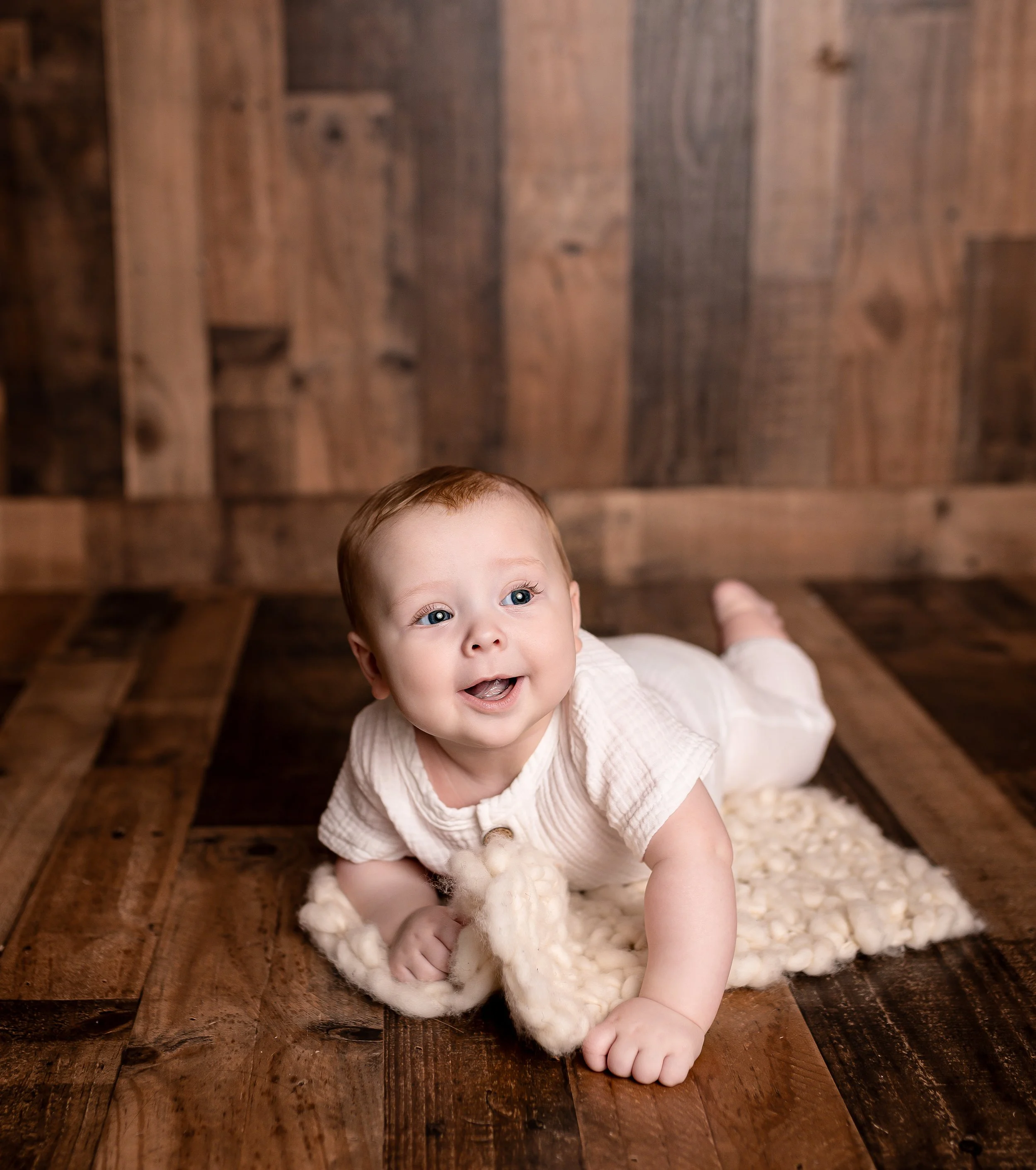 Candid shot of baby crawling during a milestone session