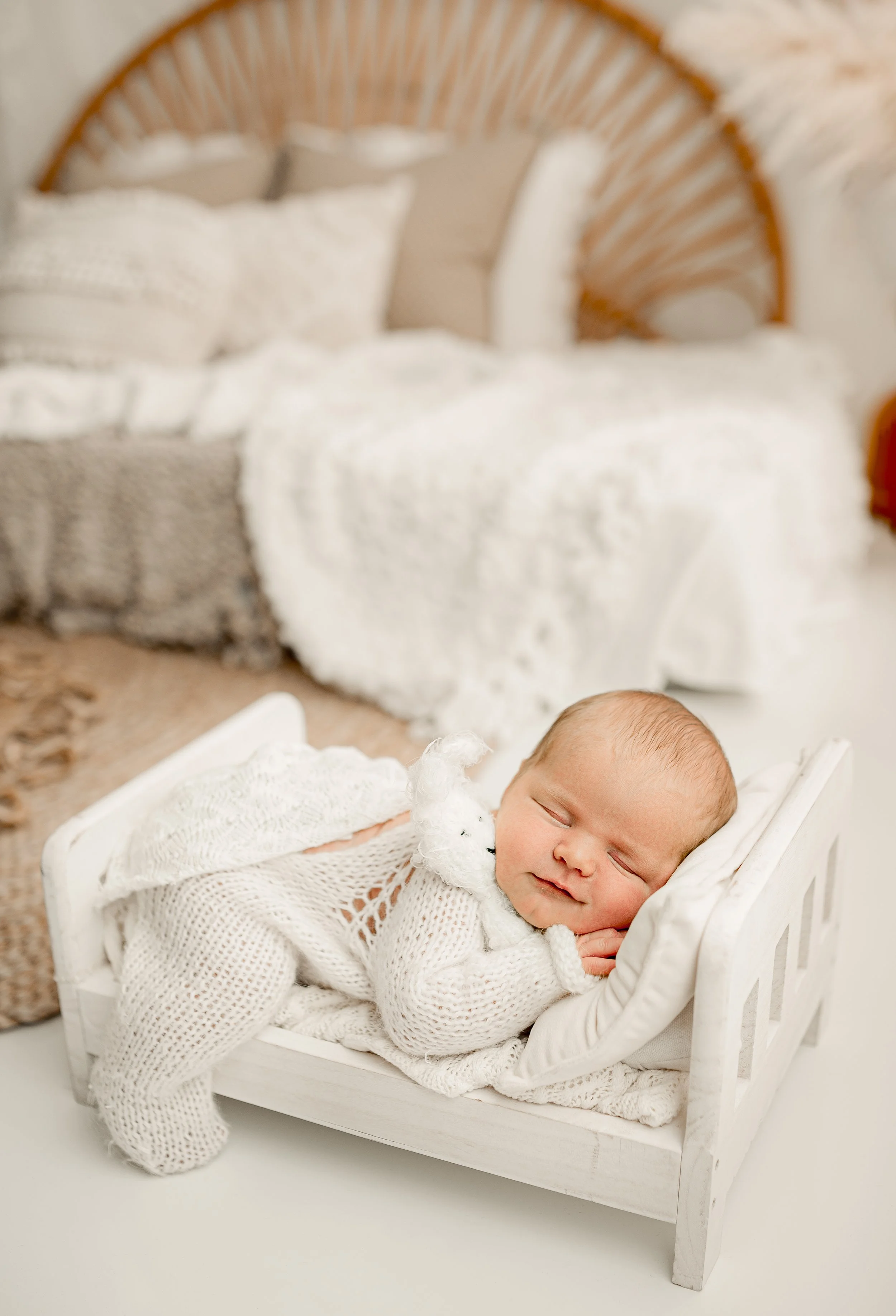 Newborn posed on a bed during a photo shoot