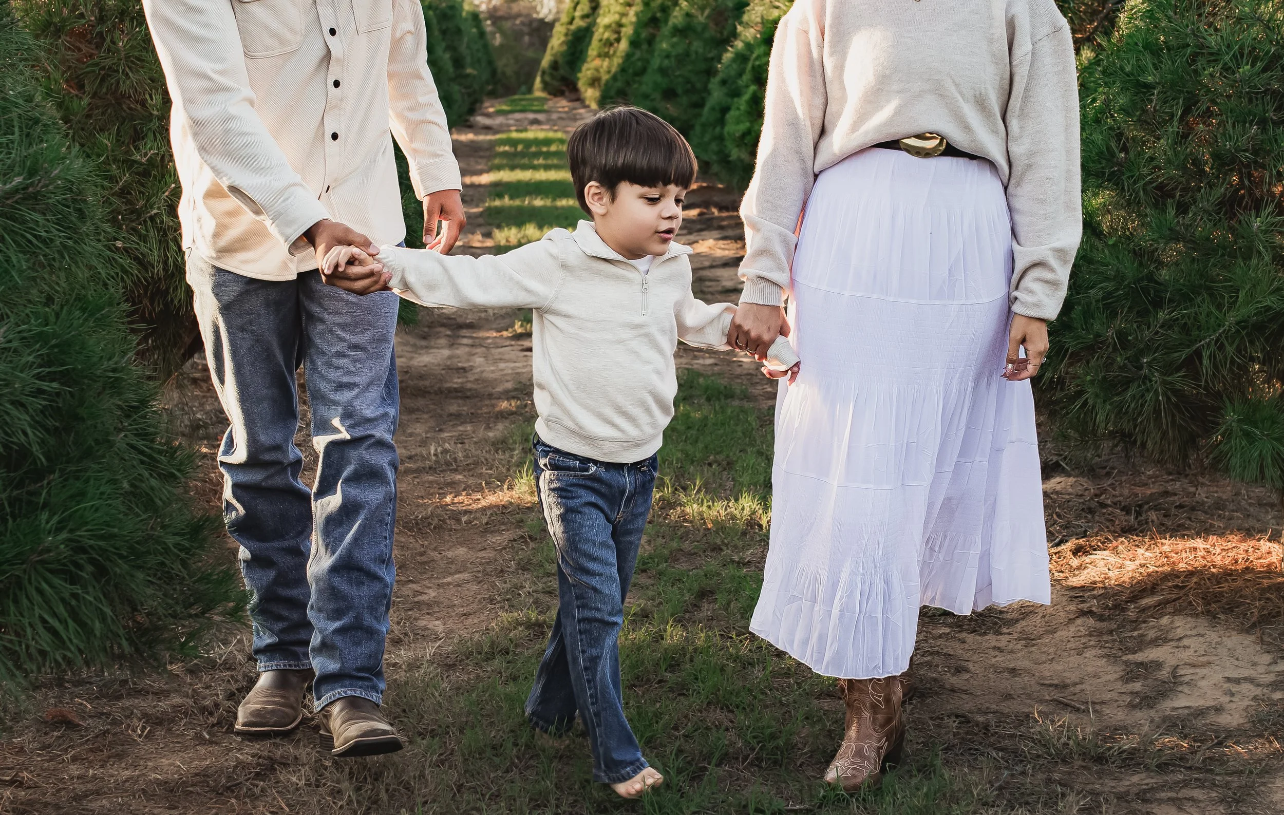Family walking hand-in-hand during an outdoor photography session