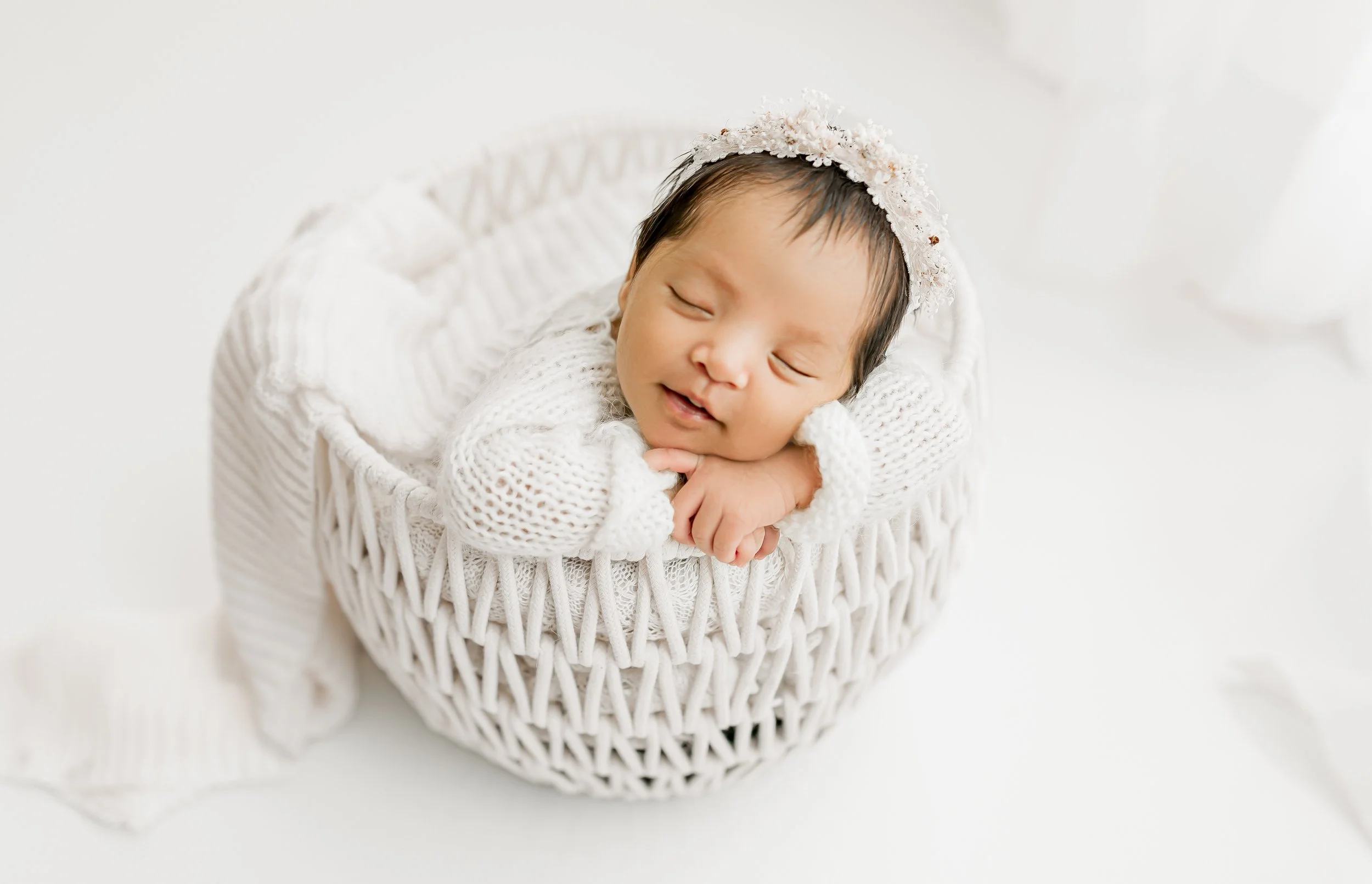 Newborn baby sleeping peacefully on a prop in Austin studio