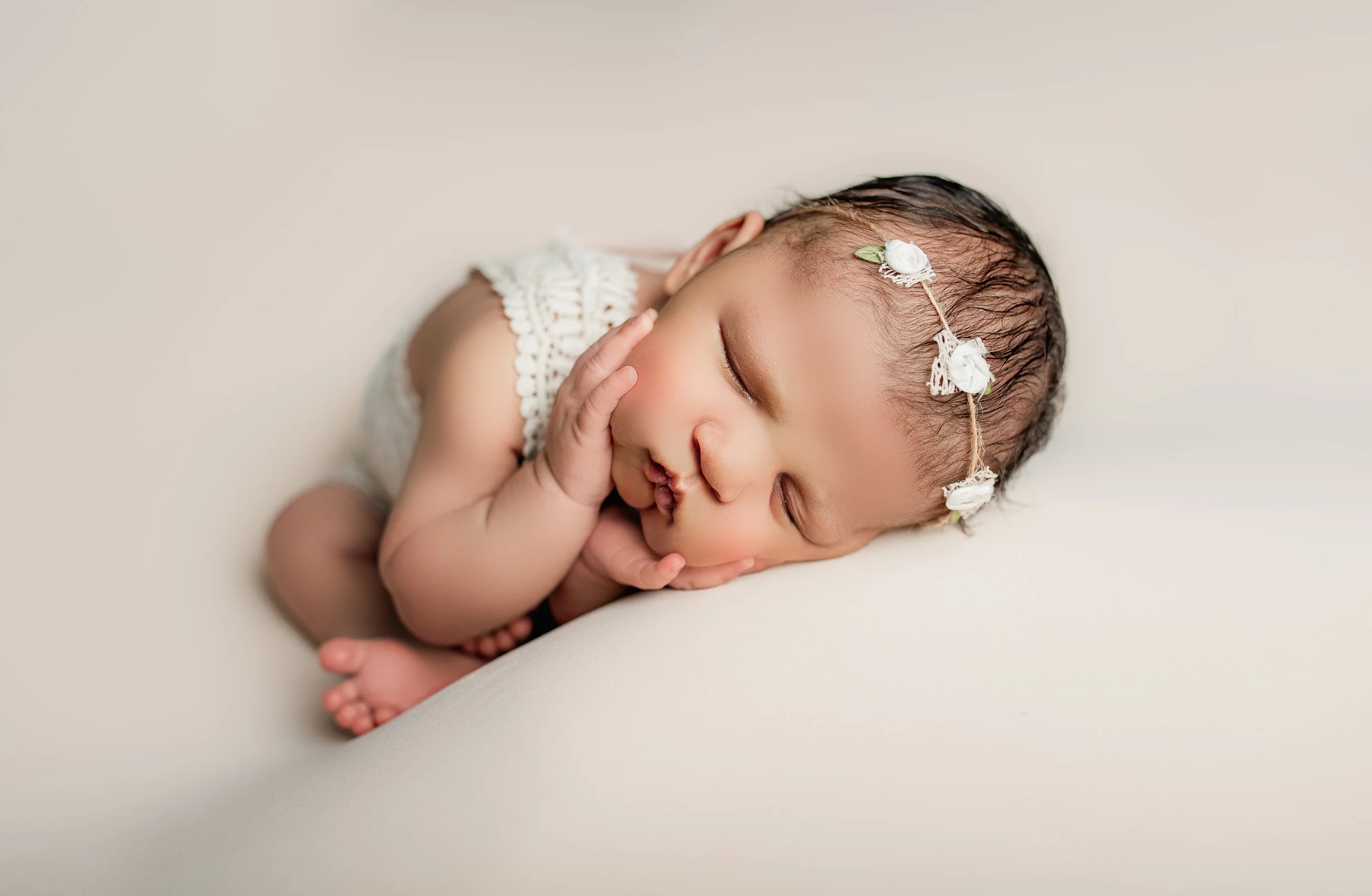 Posed newborn baby sleeping during studio photo session in Round Rock, TX