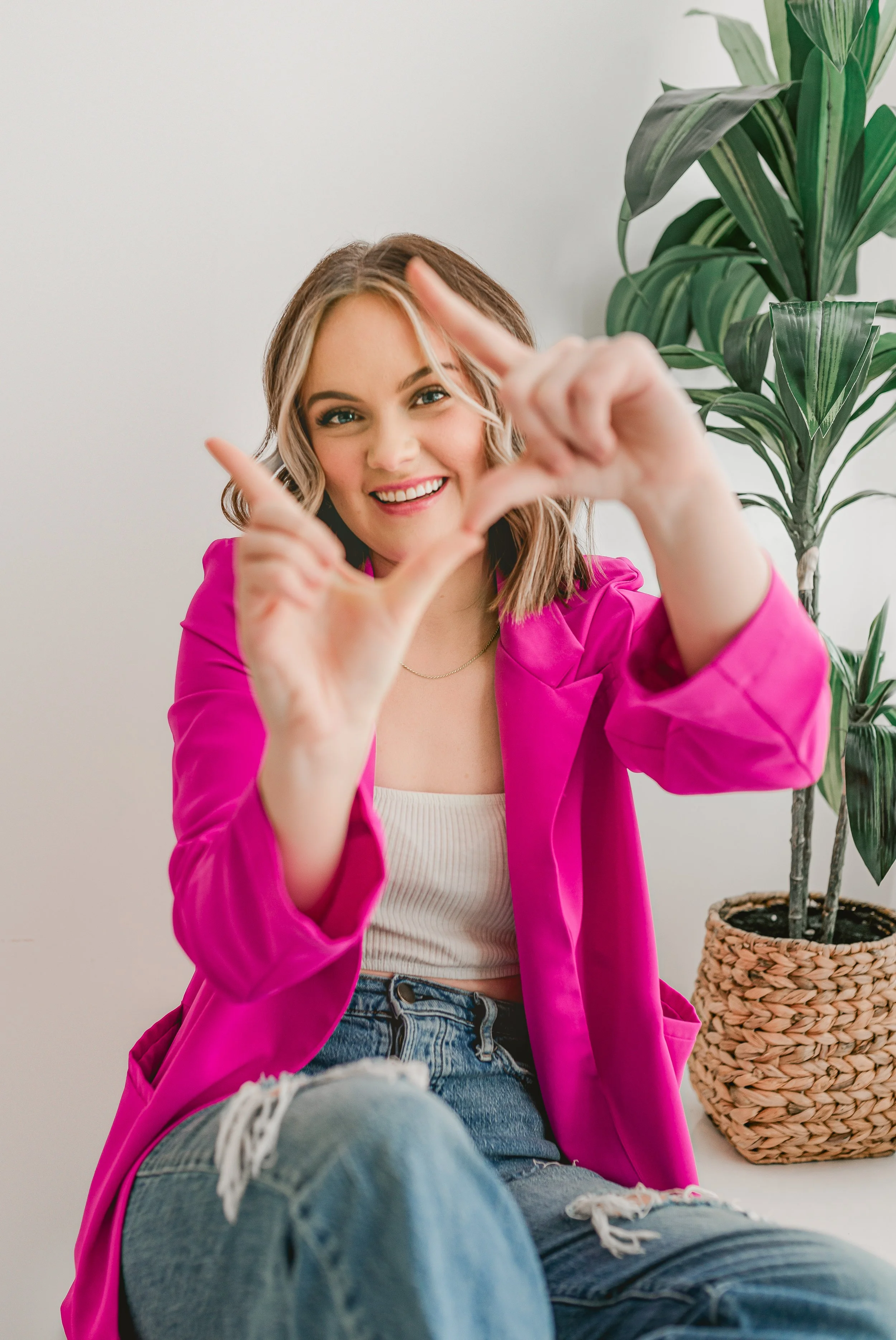 award winning photographer smiling behind a camera for her headshots in Austin