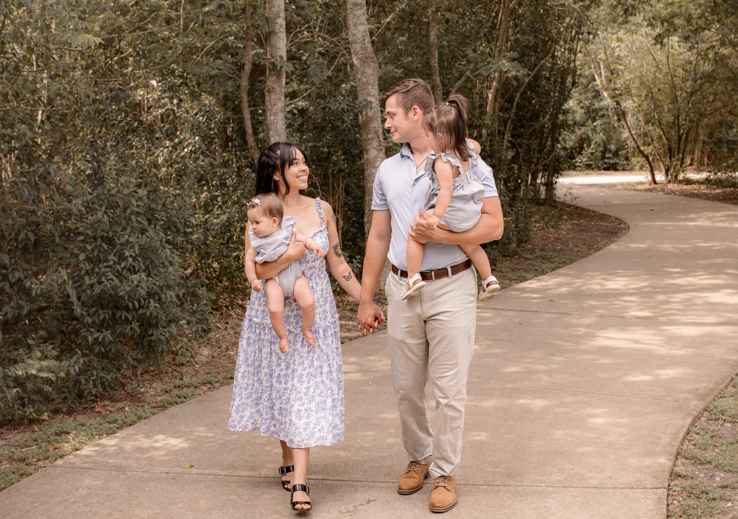 Family of four walking together in a park in Round Rock, TX