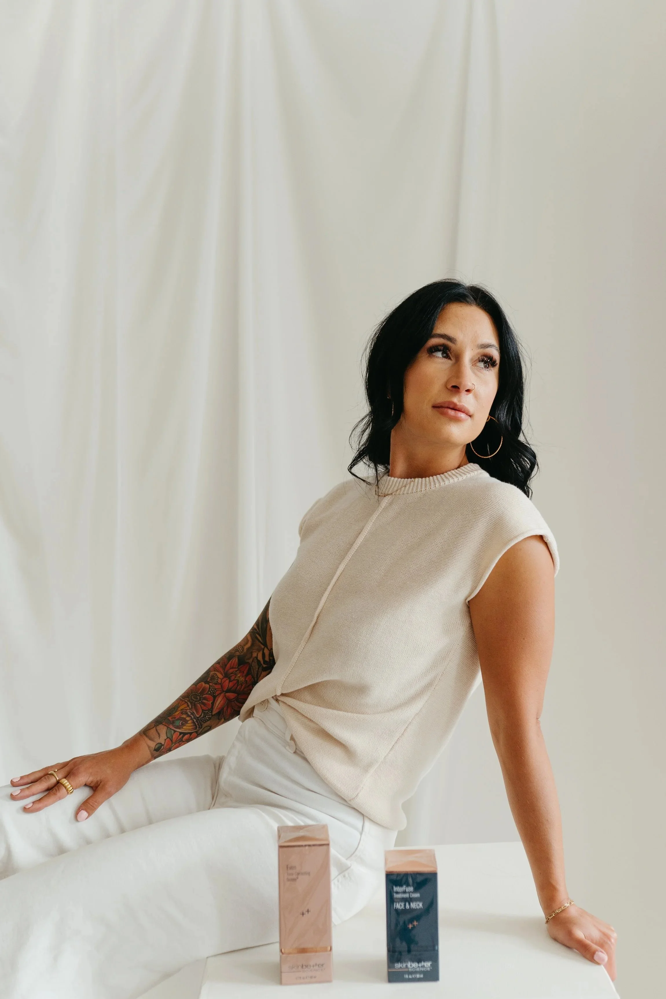 Capitol Cryo owner Tannah sitting next products used during custom facials Salem, OR