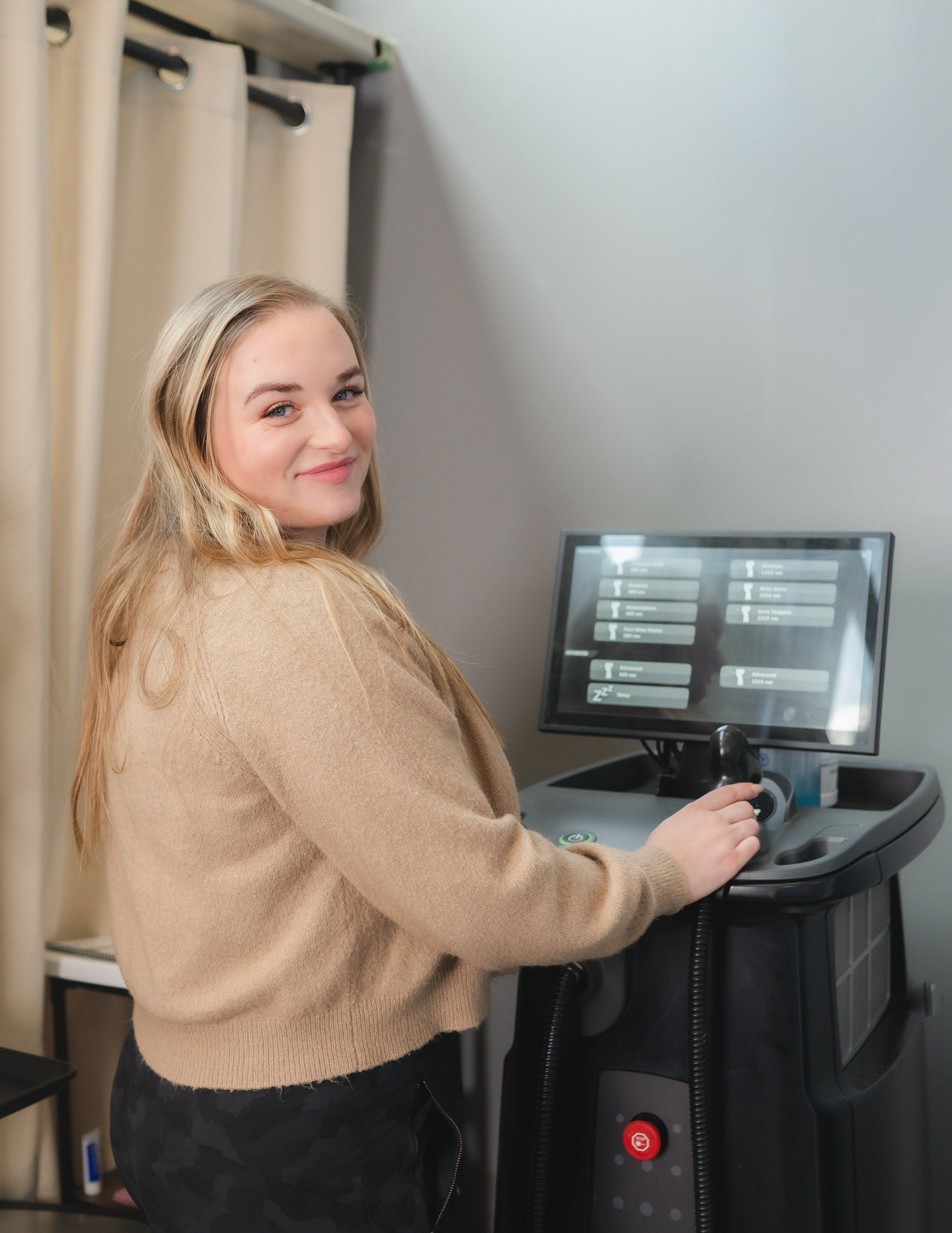 Capitol Cryo MedSpa employee Elizabeth standing next to cryotherapy machine in Salem, Oregon