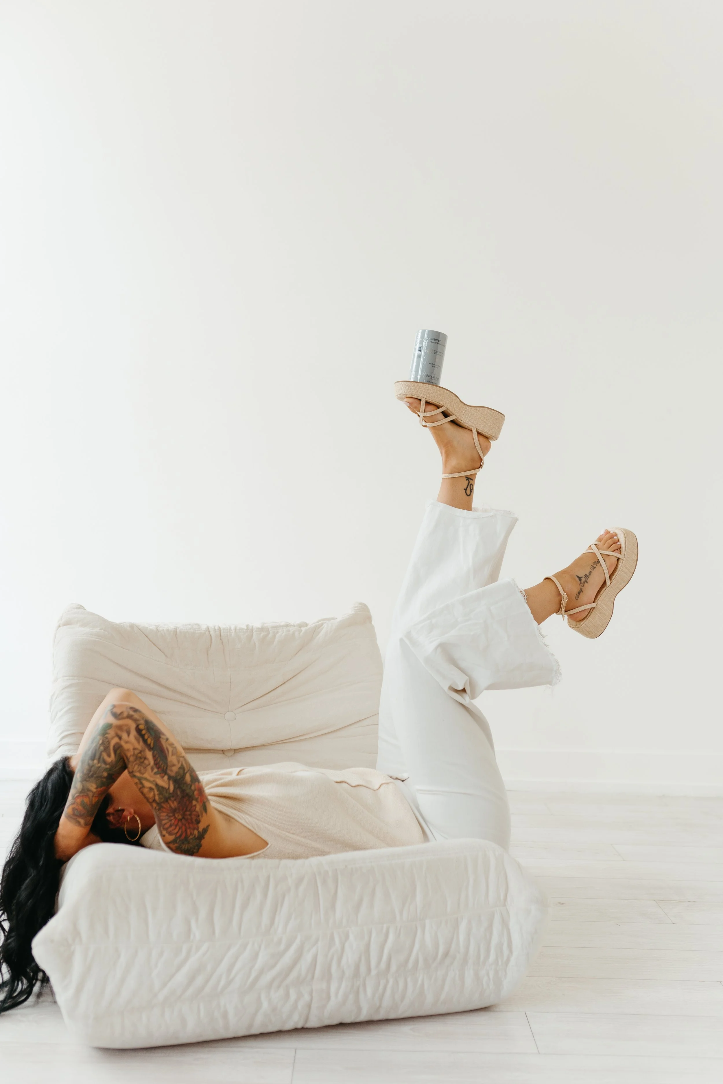 Tanah owner of Capitol Cryo balancing a product for custom facials on her foot Salem, Oregon