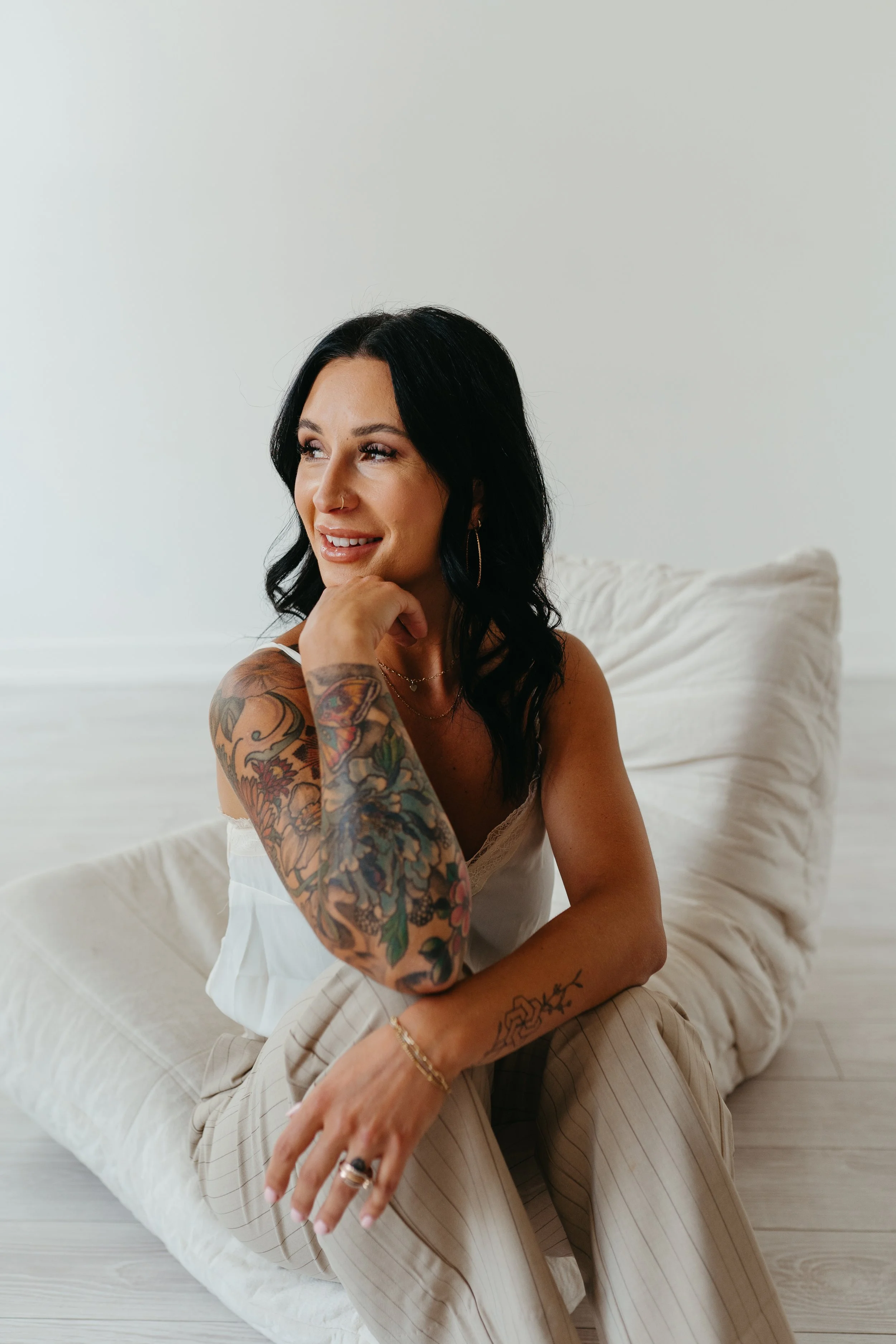 Tanah Lines the owner of Capitol Cryo Medspa is sitting down and looking away in Salem Oregon