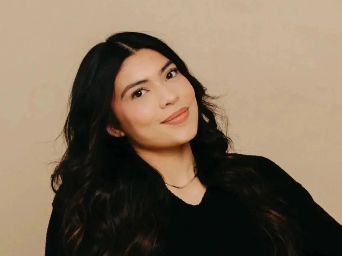 Lizbeth a licensed esthetician at capitol cryo medspa is sitting and smiling in salem oregon