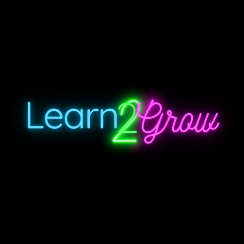 Neon sign reading 'Learn 2 Grow' with 'Learn' in blue, '2' in green, and 'Grow' in pink on a black background.