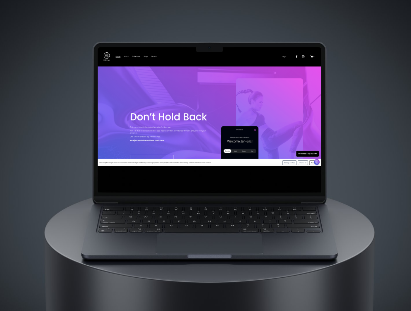 Laptop displaying a fitness website with a purple and blue background and the text 'Don't Hold Back.'