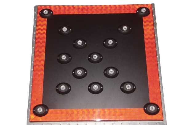 A black square game board with ten circular black discs and orange checkered border, with black corner bumpers, used for a strategic tabletop game.