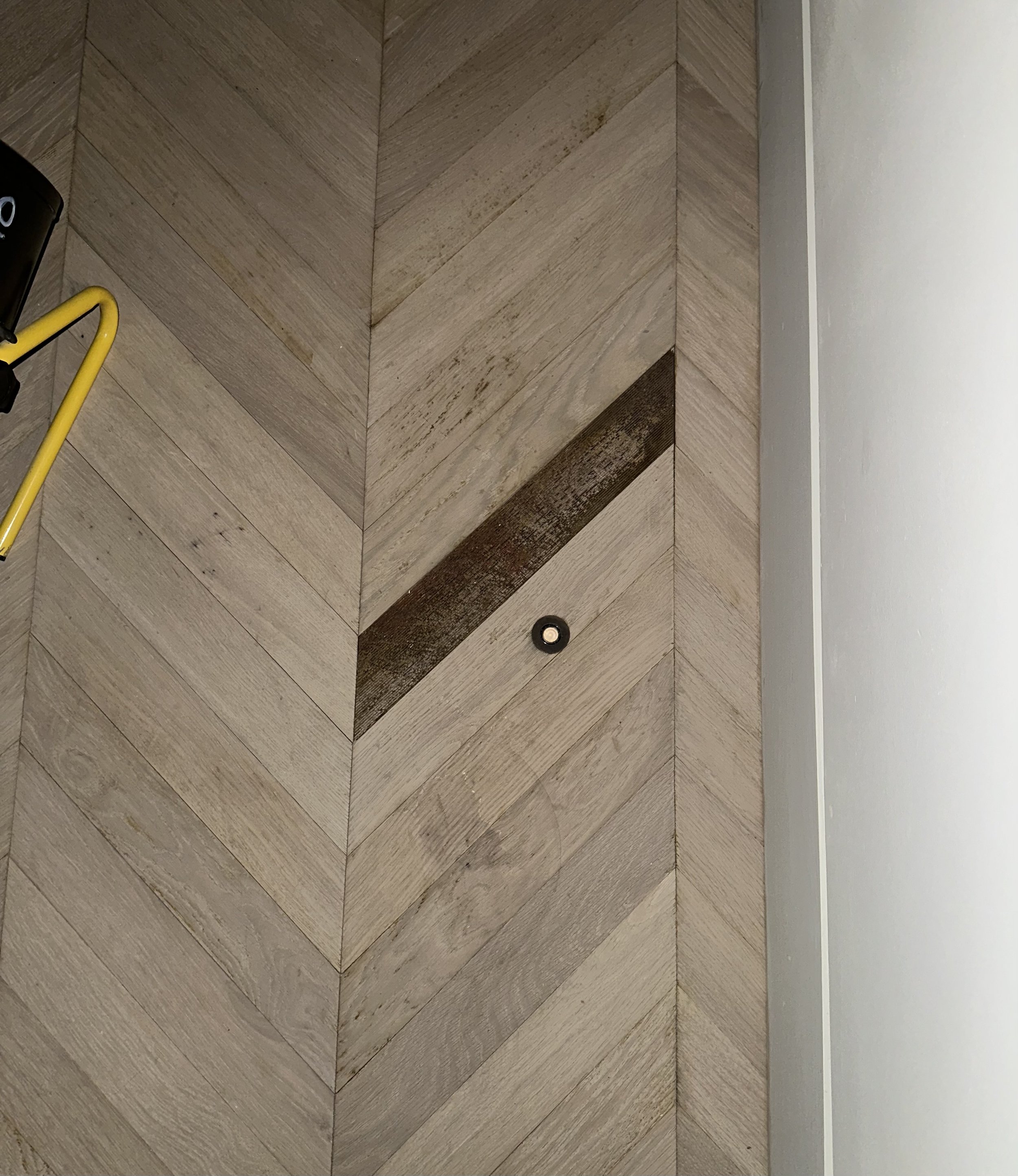 Documenting the effects of a Category 1, Class 2 water event, including glue failure and delamination in engineered chevron flooring.