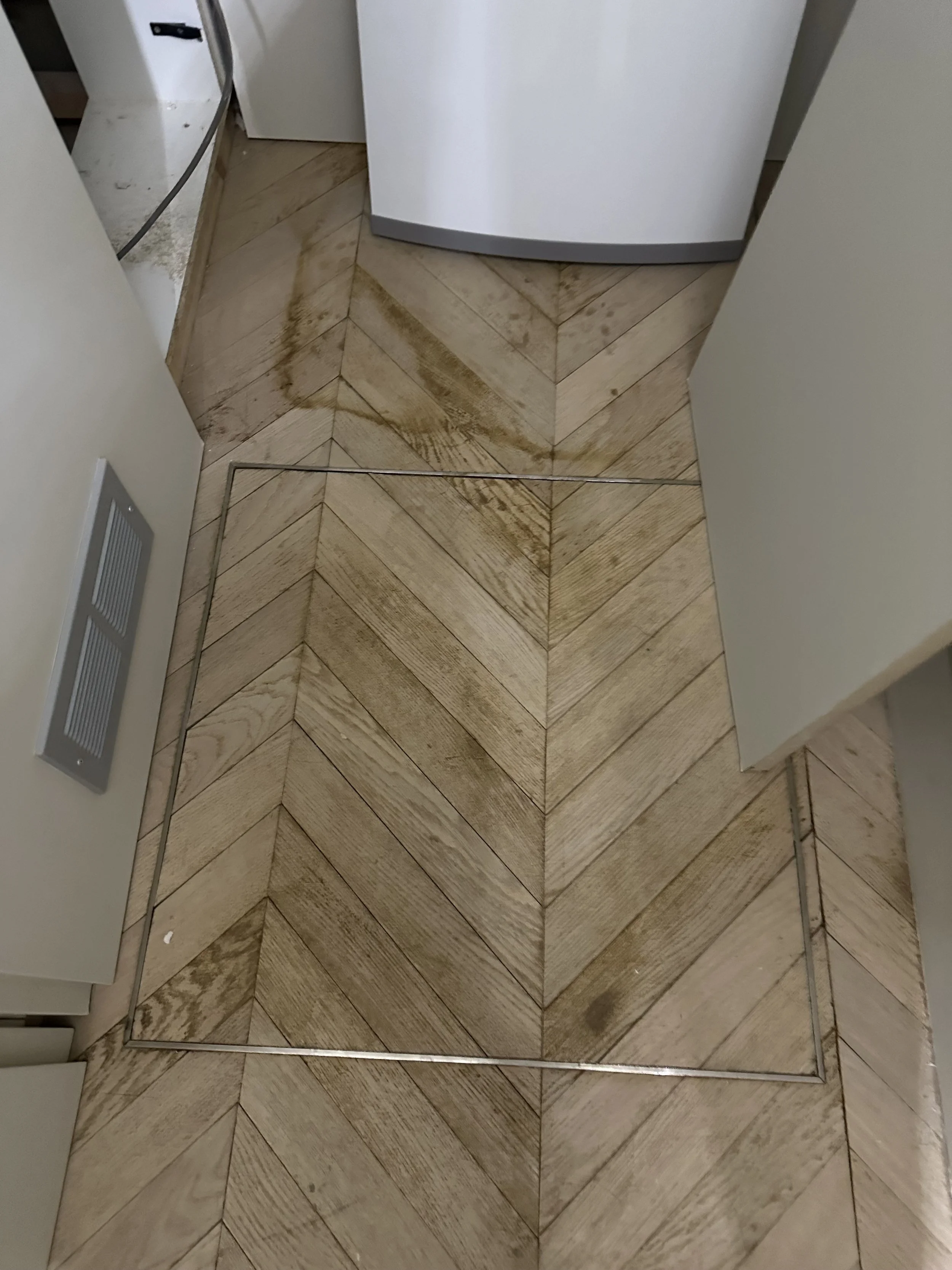 Documenting the impact of Category 1, Class 2 water ingress, including capillary moisture action and chemical interaction with tannins in the oak wear layer.