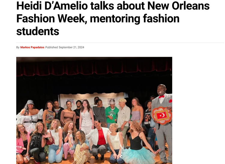Group of people on stage, diverse in age, gender, and ethnicity, posing for a photo at New Orleans Fashion Week event, with a person holding a red and gold award.