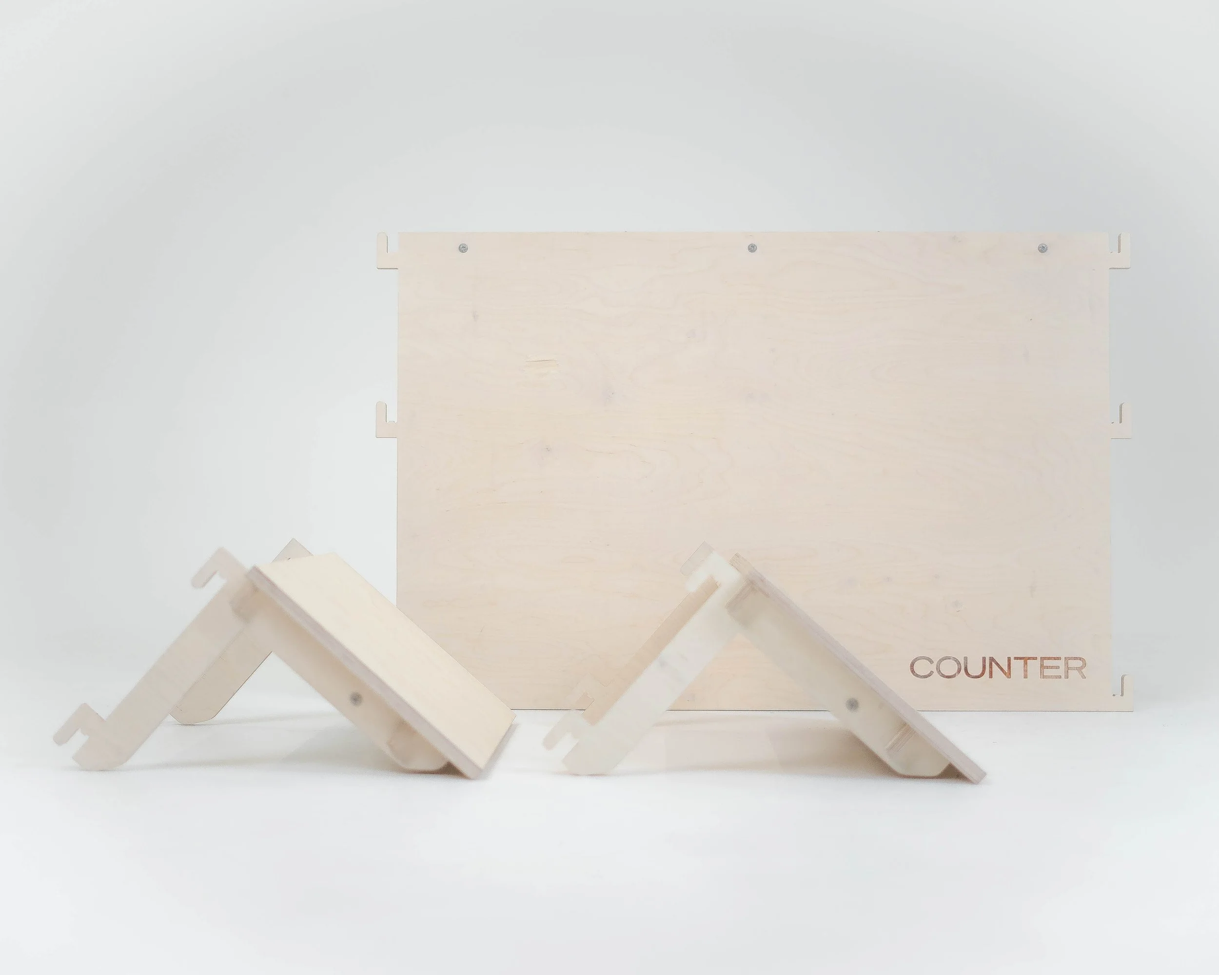 A wooden counter with small wooden platforms in front of it, on a white background.