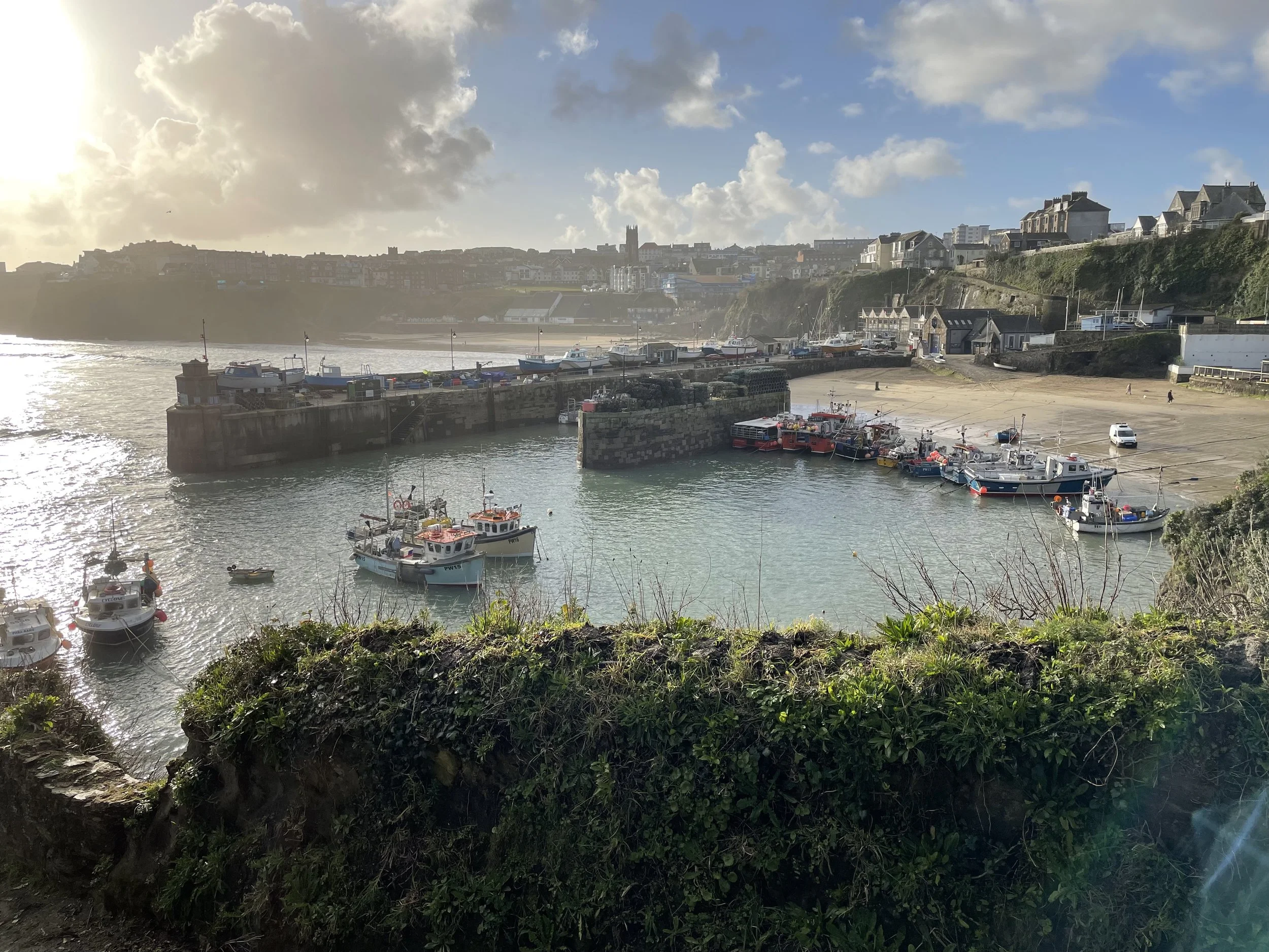 A harbour with fishing boats and sunshine on the water