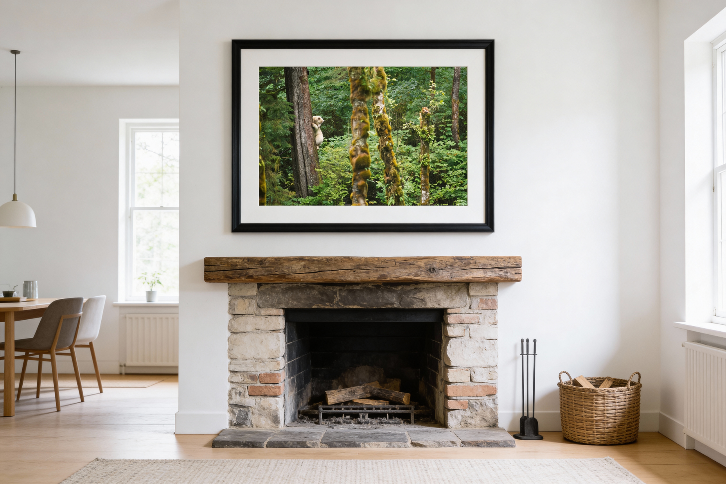 Living room with a brick fireplace, wooden mantel, and framed forest photograph above the mantel; wicker basket and fireplace tools on the floor.