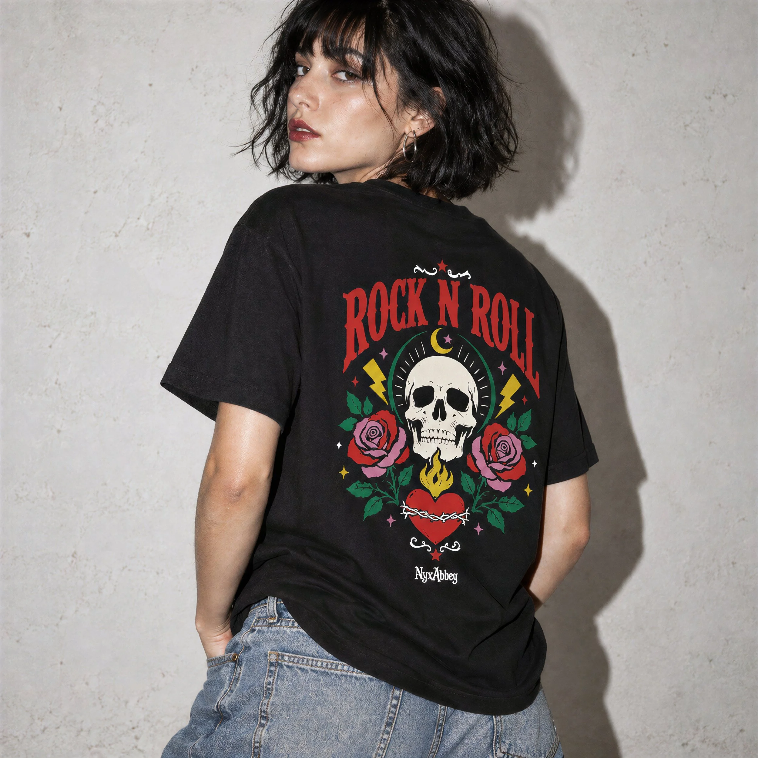 Model wearing NyxAbbey Rock N Roll Skull black graphic T-shirt with large back print