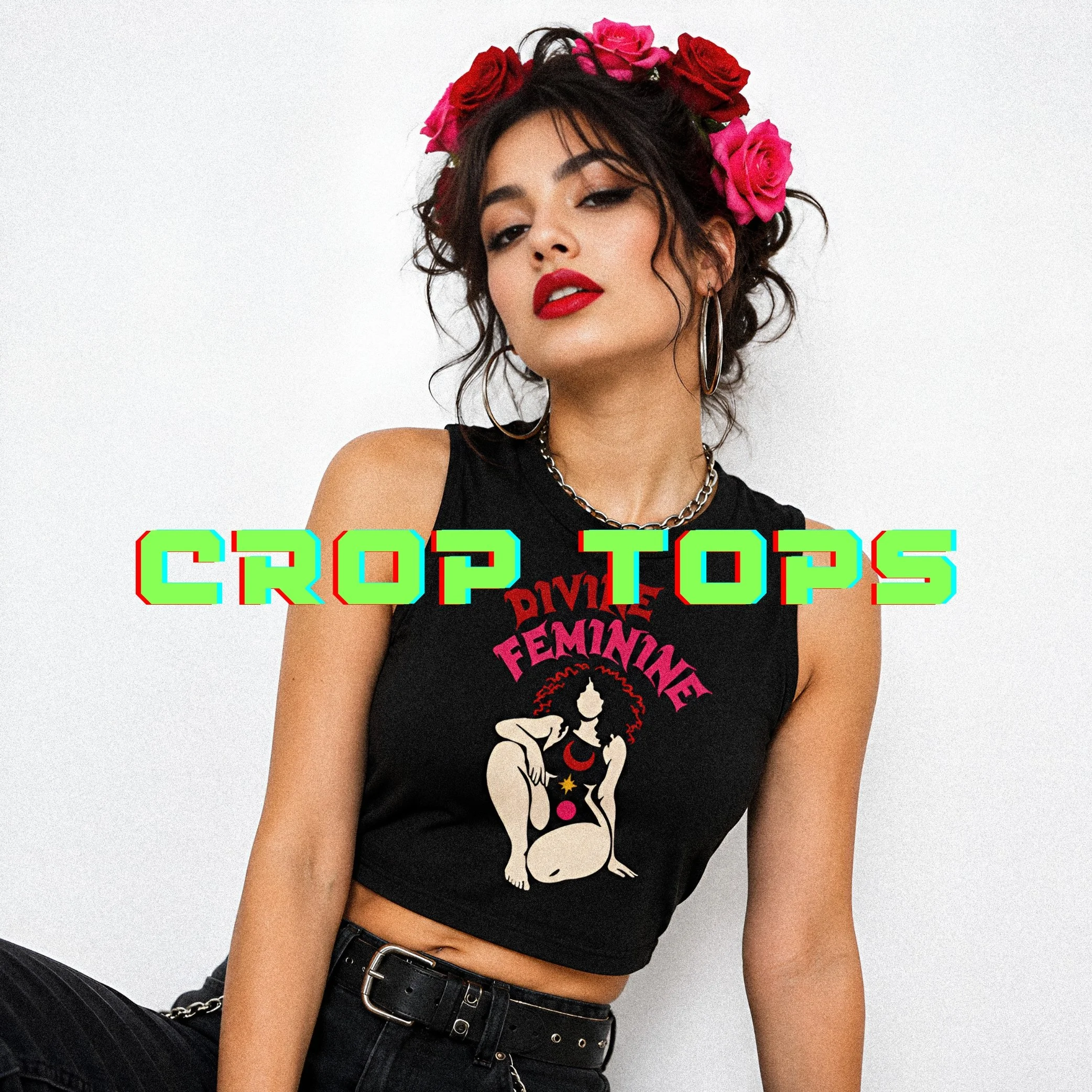 A woman with dark curly hair wearing a crown of pink and red roses, red lipstick, hoop earrings, a chain necklace, a black sleeveless shirt with bold text, and black pants with a belt.