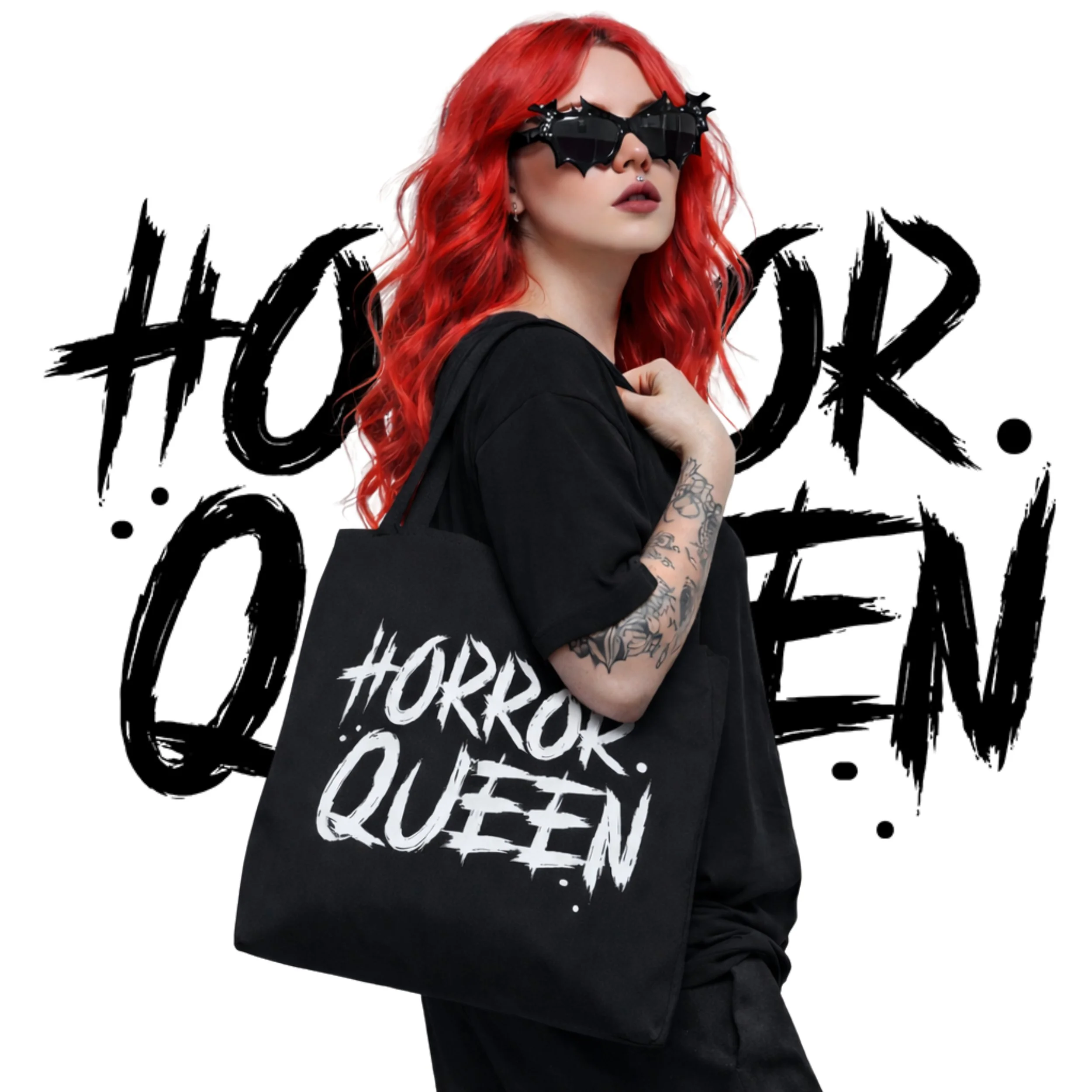 A woman with red hair, wearing black sunglasses, a black T-shirt, carrying a tote bag that says 'Horror Queen.' Behind her is a white background with bold, black graffiti-style text that also says 'Horror Queen.'
