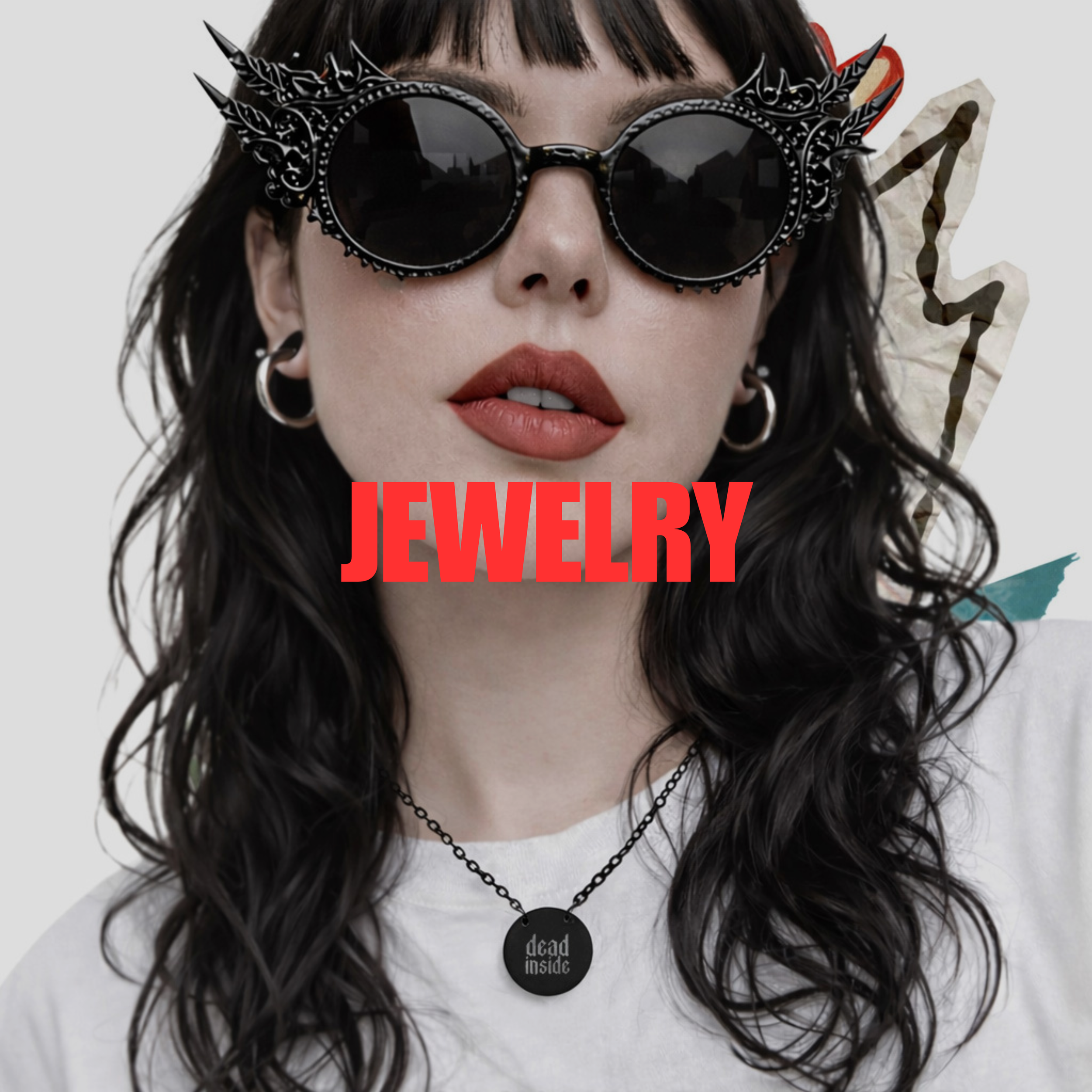 Woman with dark wavy hair wearing decorative black sunglasses, hoop earrings, a necklace with a round pendant reading 'dead inside,' and a white shirt. The word 'JEWELRY' is overlaid in bold red text.