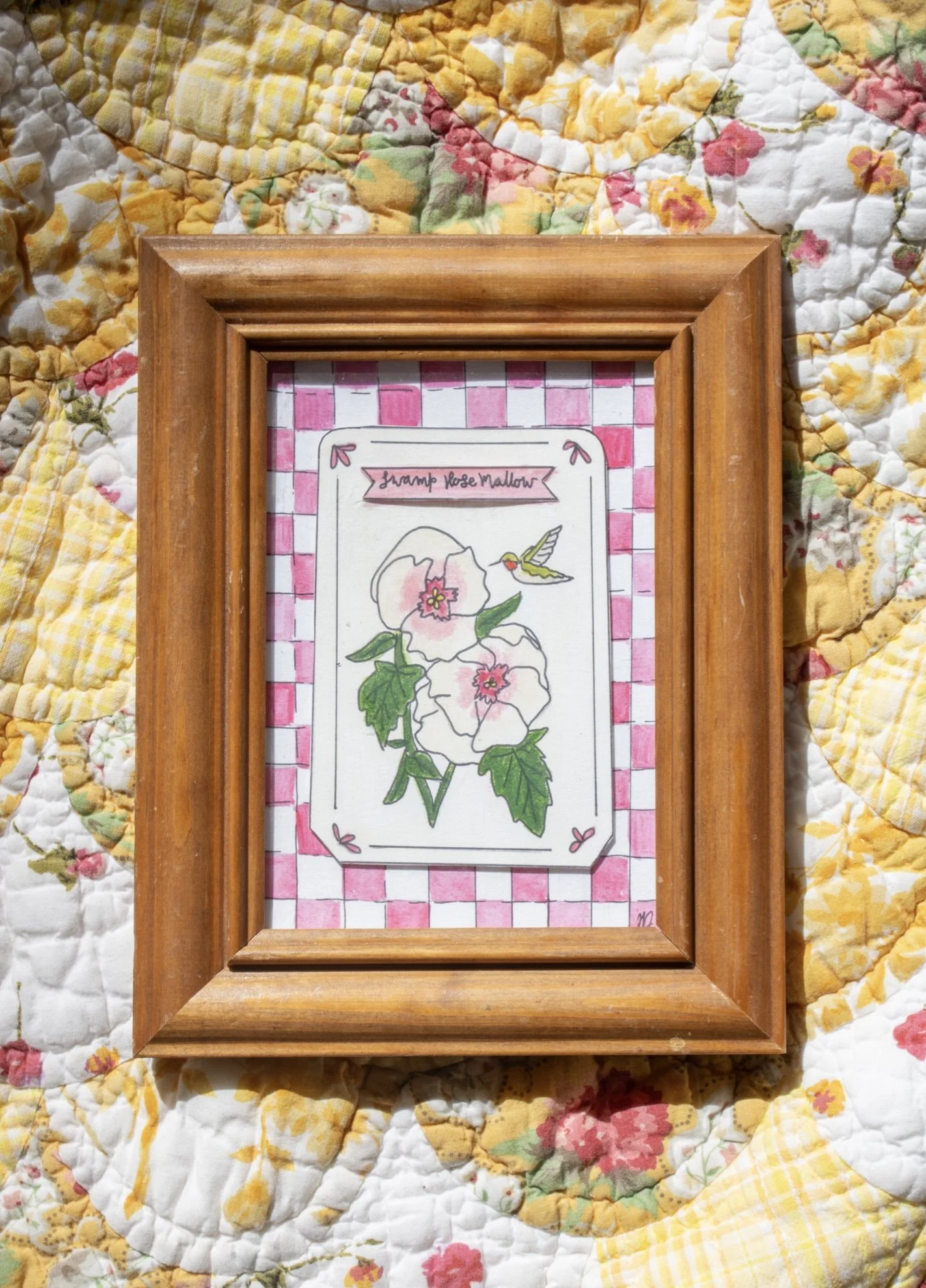 A seed packet inspired watercolor featuring giant hibiscus on a pink checkered background