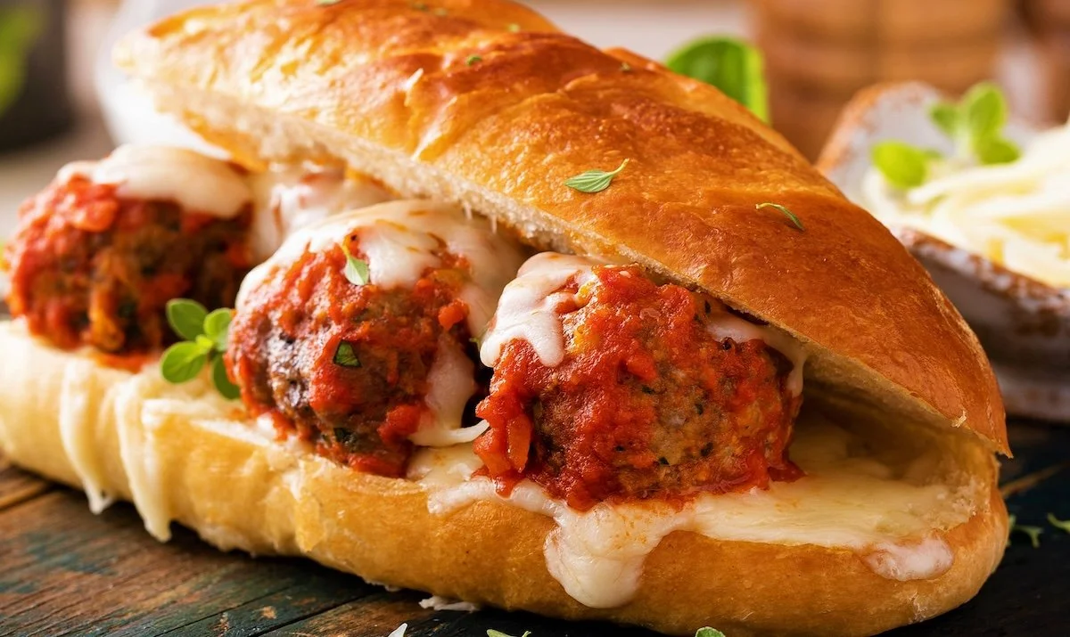 Toasted meatball sub made with Denmark Foods Italian sausage meatballs, marinara sauce, and melted mozzarella cheese on a hoagie roll.
