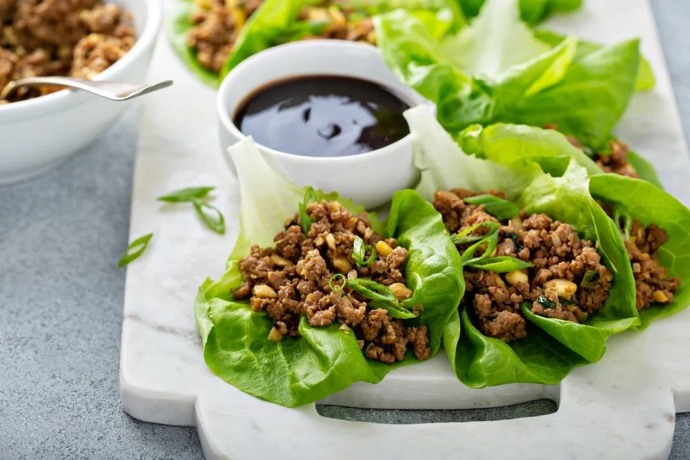 Chicken lettuce wraps filled with seasoned ground chicken, water chestnuts, mushrooms, and green onions served in crisp lettuce leaves.