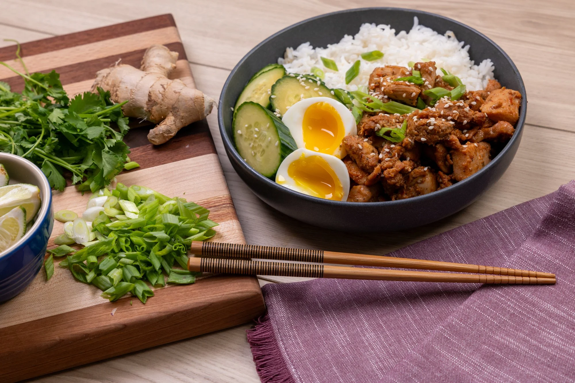 Denmark Foods skillet-ready seasoned meat served in a rice bowl with fresh ginger, cucumbers, and green onions