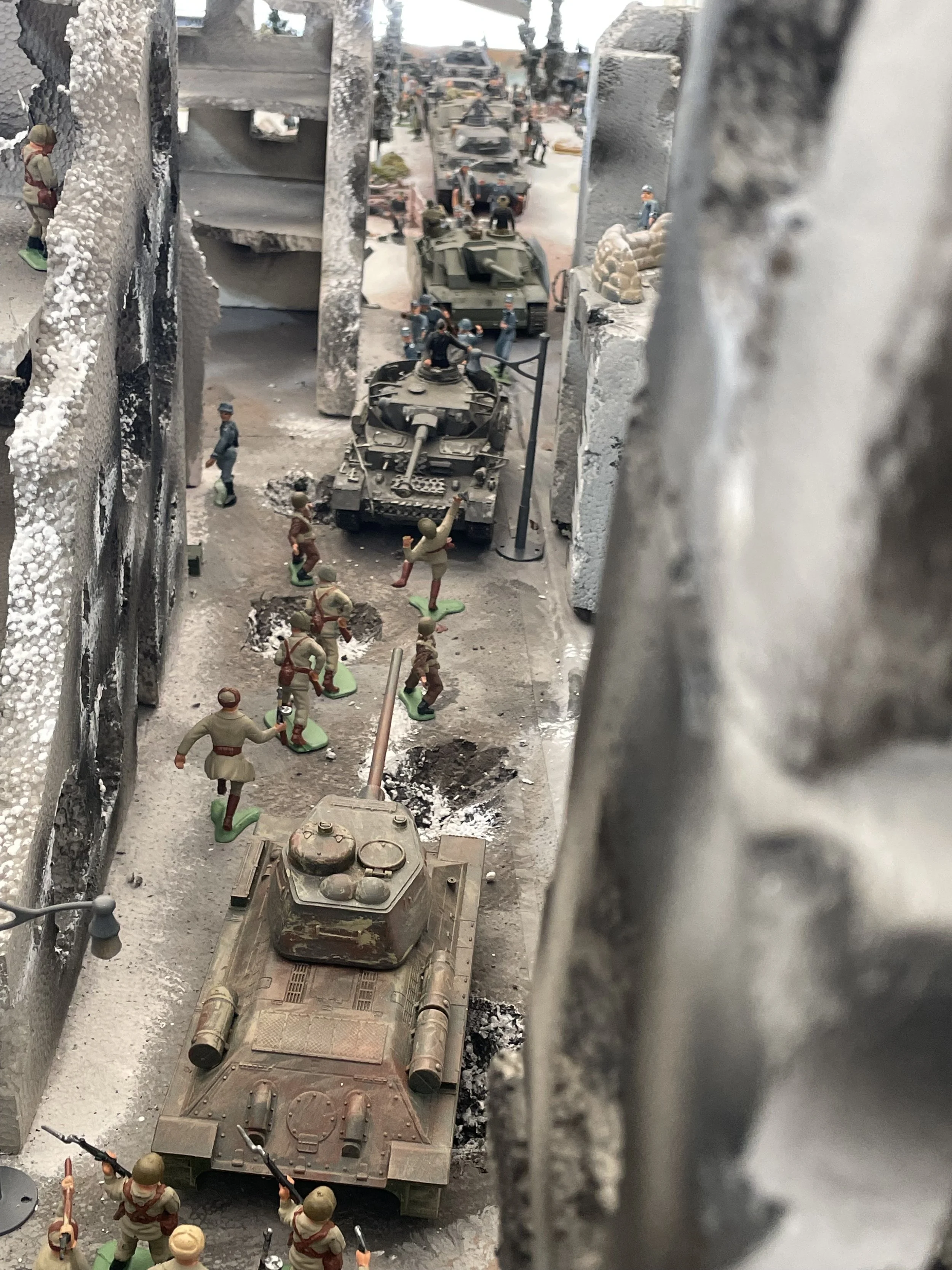 Inside the city, narrow streets and ruined choke points quickly turn the advance into a bottleneck. Armor and infantry crowd the same shattered avenues, and the assault begins to lose momentum in a grinding urban stalemate.