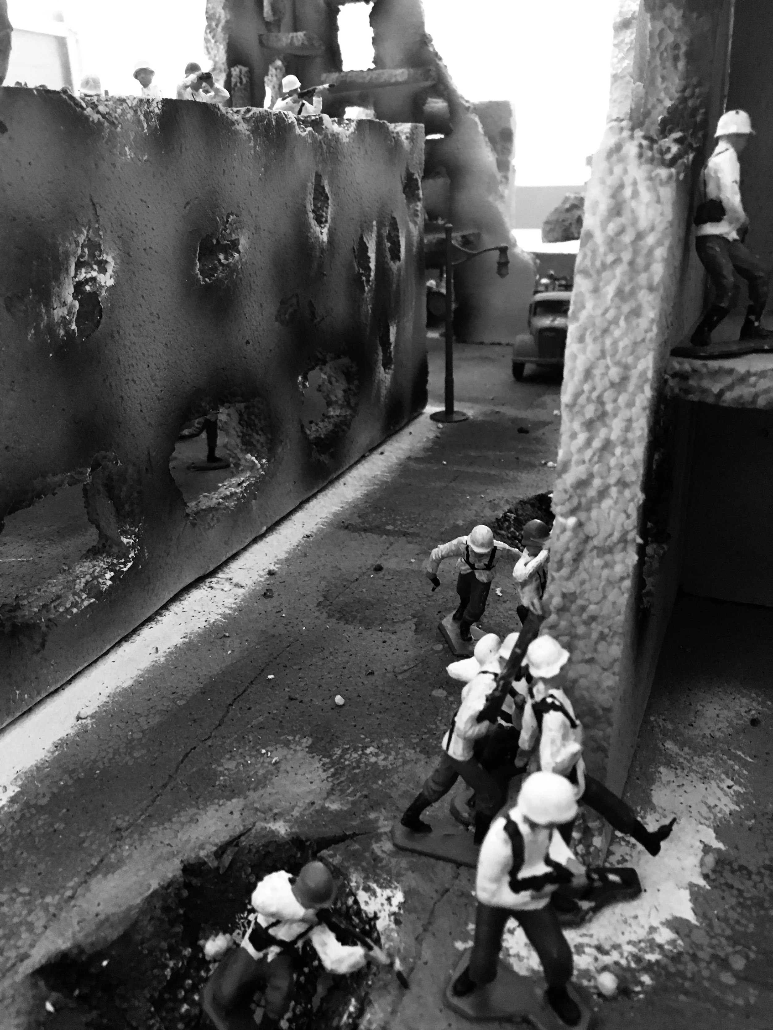 Urban warfare engulfs the ruins of Stalingrad—German infantry fighting block by block through shattered concrete and smoke.