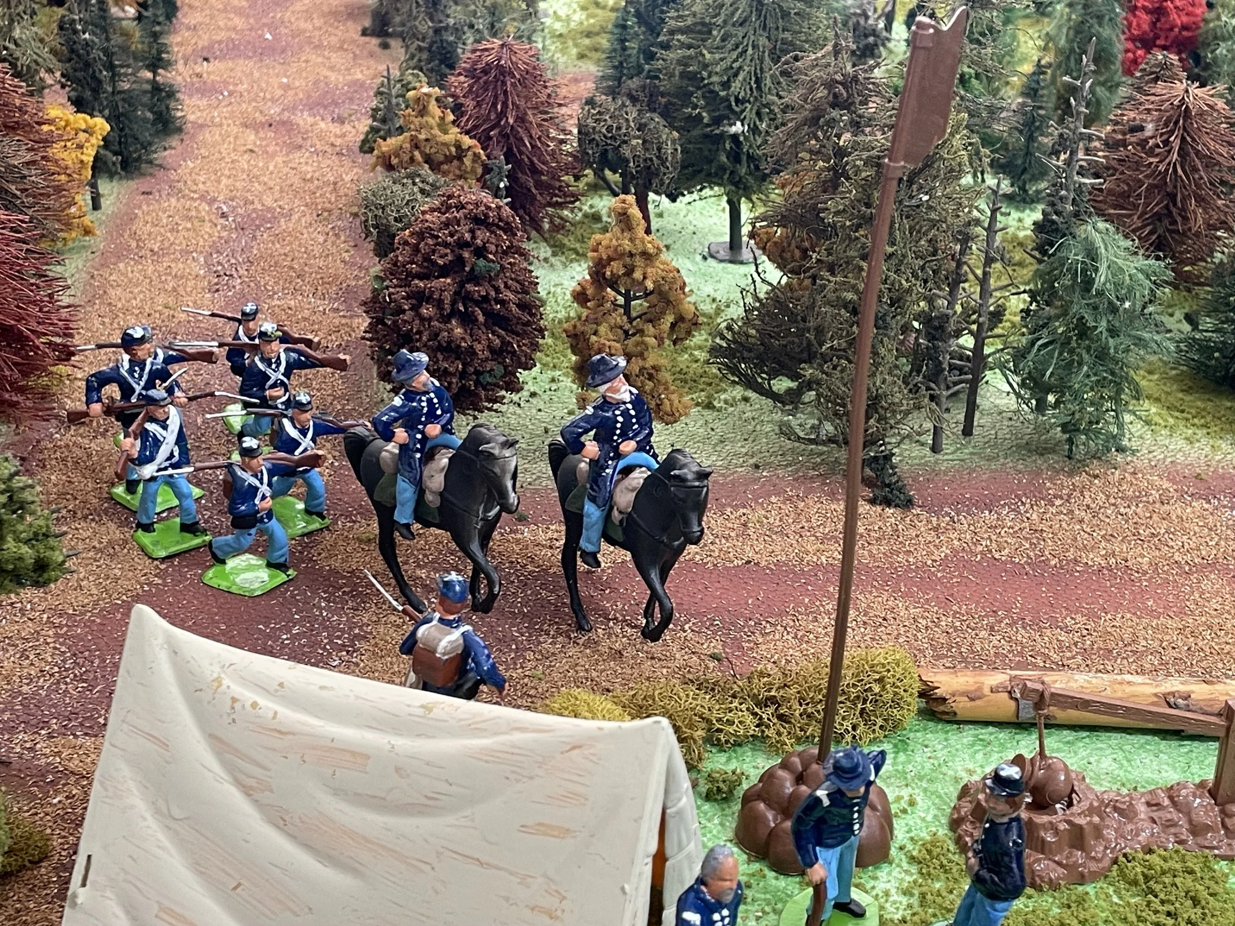 An officer returns from camp with a small escort. Six infantrymen accompany him on foot — close guard, message carriers, and insurance against sudden contact.