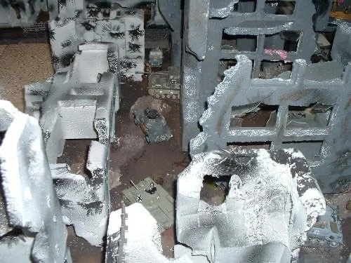 The city reduced to bones—collapsed walls, frozen rubble, and the smell of smoke trapped beneath snow.