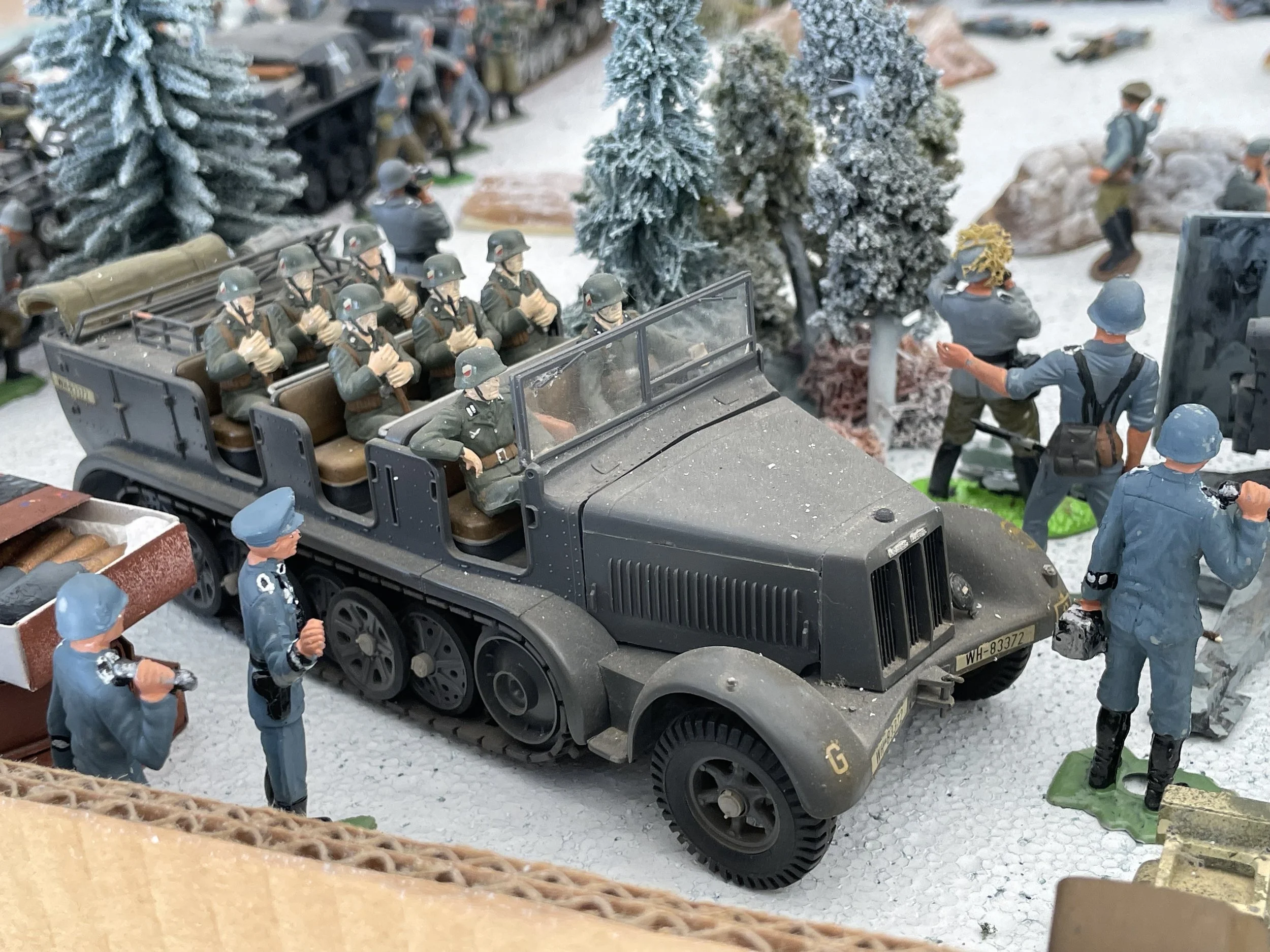 With the perimeter secured, senior personnel arrive at the forward position to begin a preliminary on-site assessment. Troops dismount under winter cover as commanders and staff gather the first reports before the next phase of the advance on Kharkov