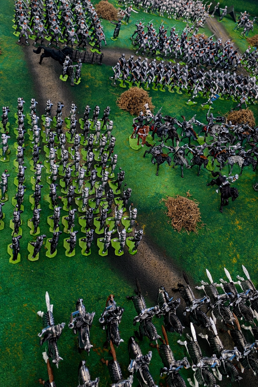 French men-at-arms look on from the rear ranks at Agincourt as the cavalry moves into position ahead of them, preparing to launch the opening assault.