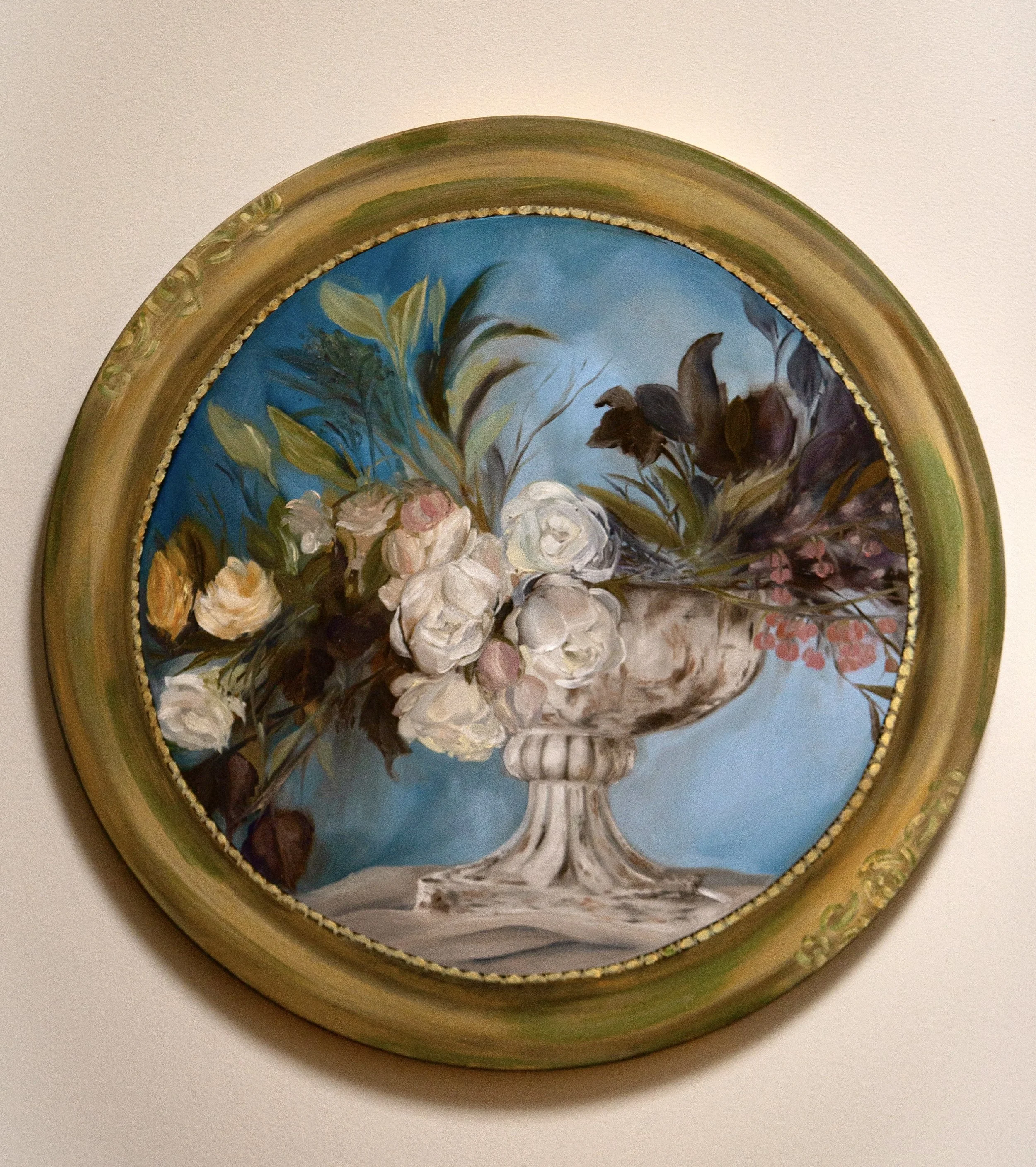 Oil painting of a white flower arrangement in a silver urn against a blue background, framed in an ornate oval gold frame.