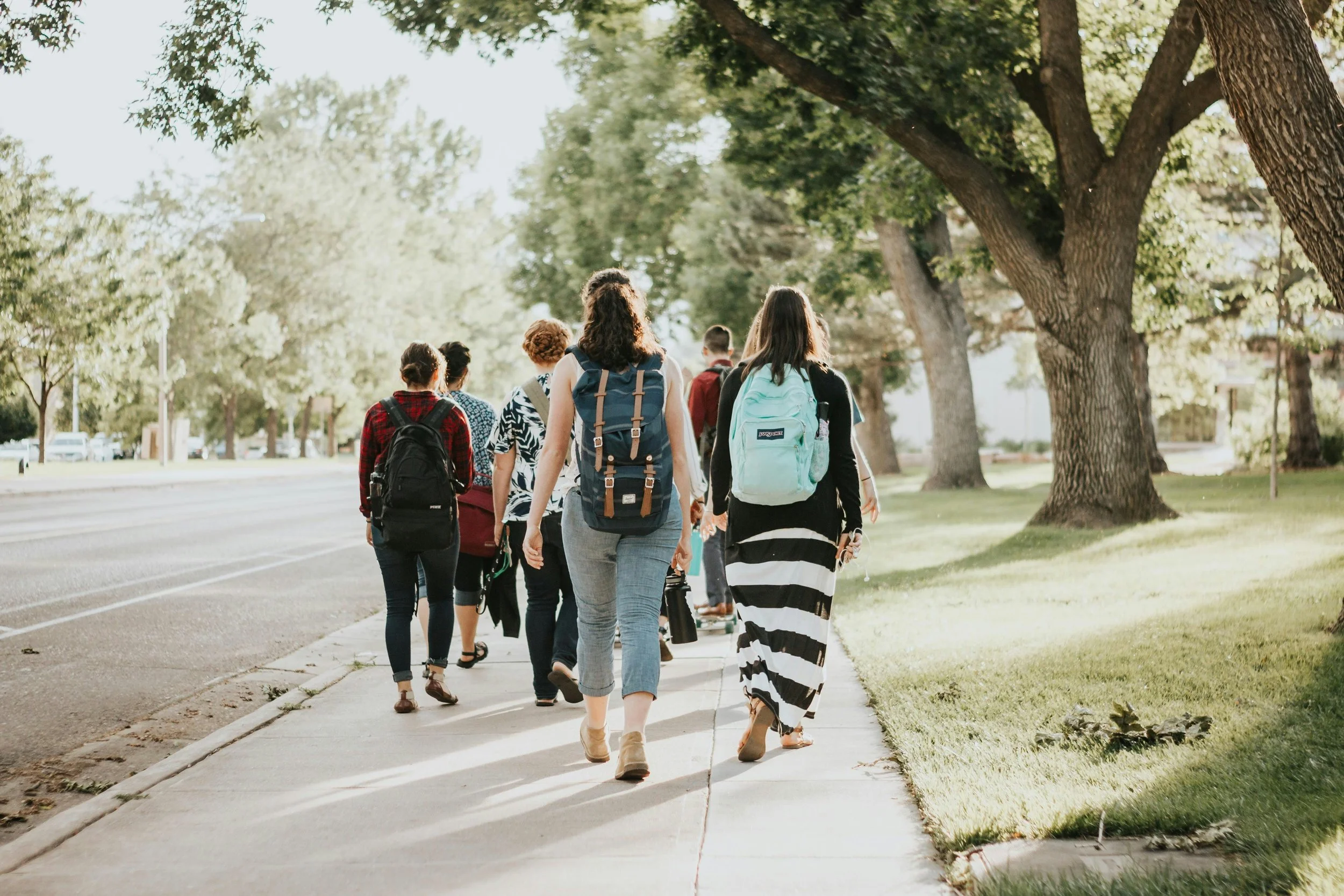 students walking with backpack