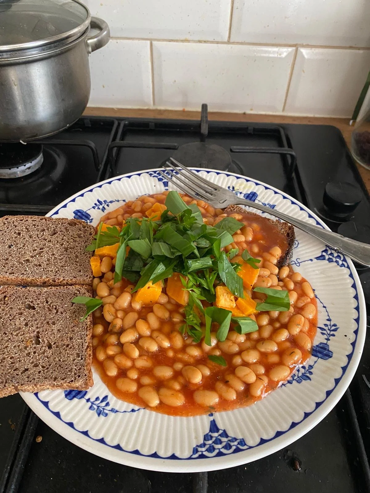 Beans on toast, sprinkled with wild garlic leaves. "A very good medicine, and delicious at this time of year." - Tom. Submitted 7th April.