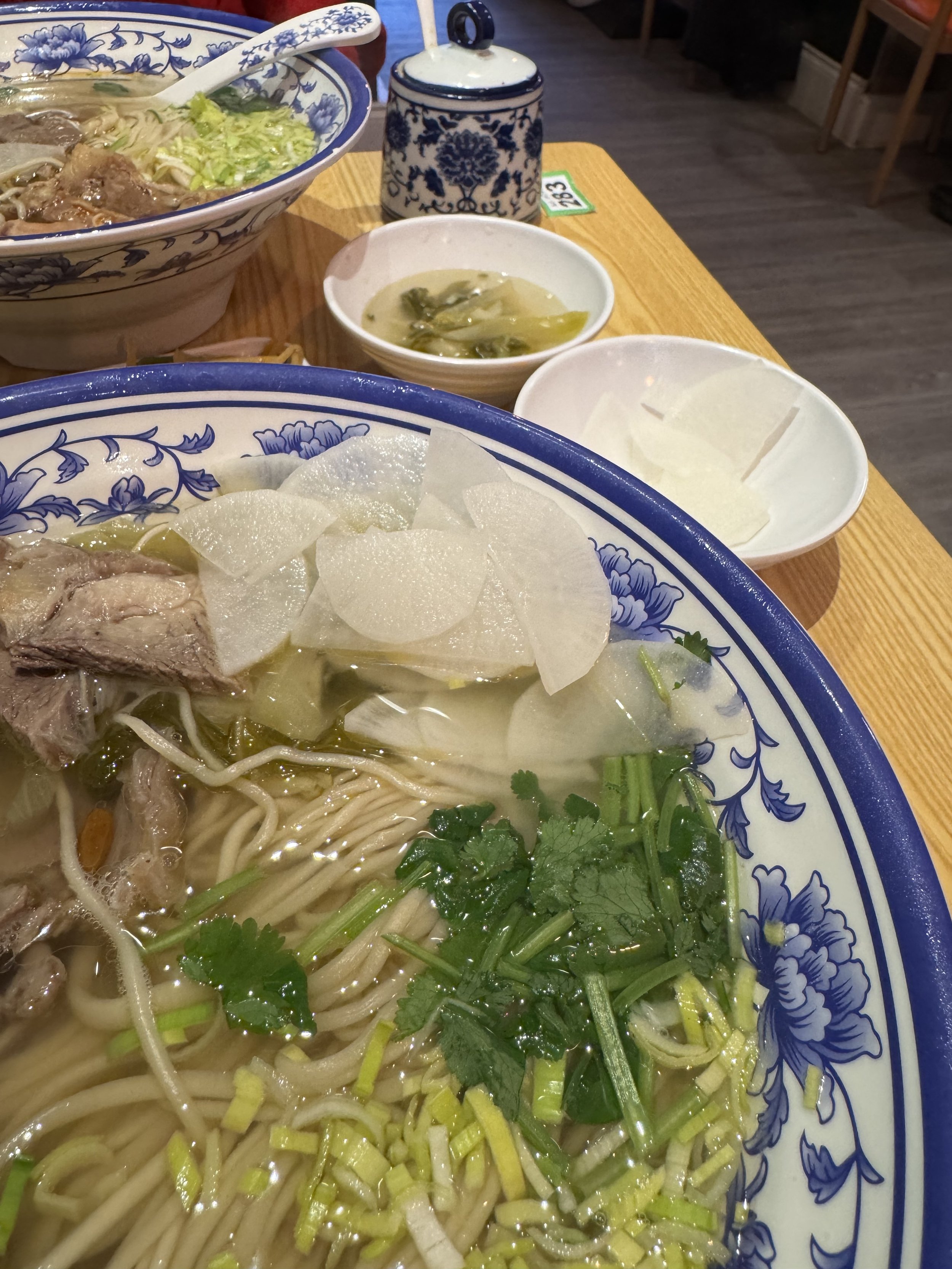 a bowl of delicious beef noodles, with raddish, spring onion and coriander, which are typical used to mark the beginning of spring as in the 咬春（biting spring）tradition. on 8th of   Feb, 2026, from Qian in Cambridge
