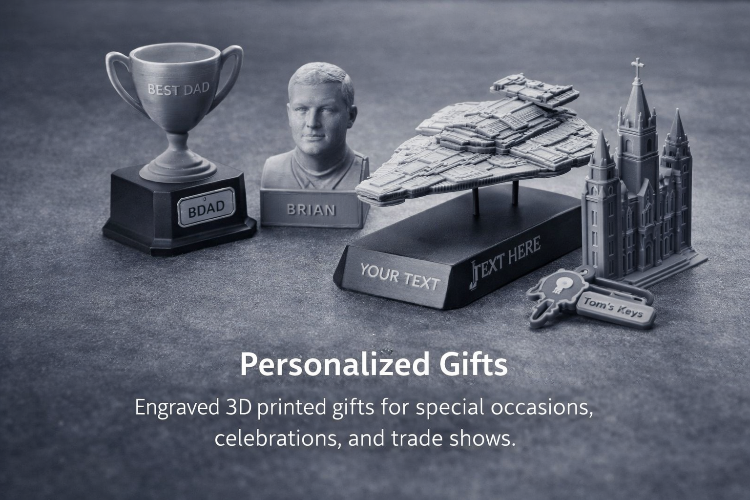 A collection of customized engraved 3D printed gifts, including a trophy with "Best Dad" inscription, a bust of a man labeled "Brian," a spaceship model, a detailed cathedral replica, and a keychain labeled "Tom's Keys," on a dark textured surface with text promoting personalized gifts for special occasions, celebrations, and trade shows.