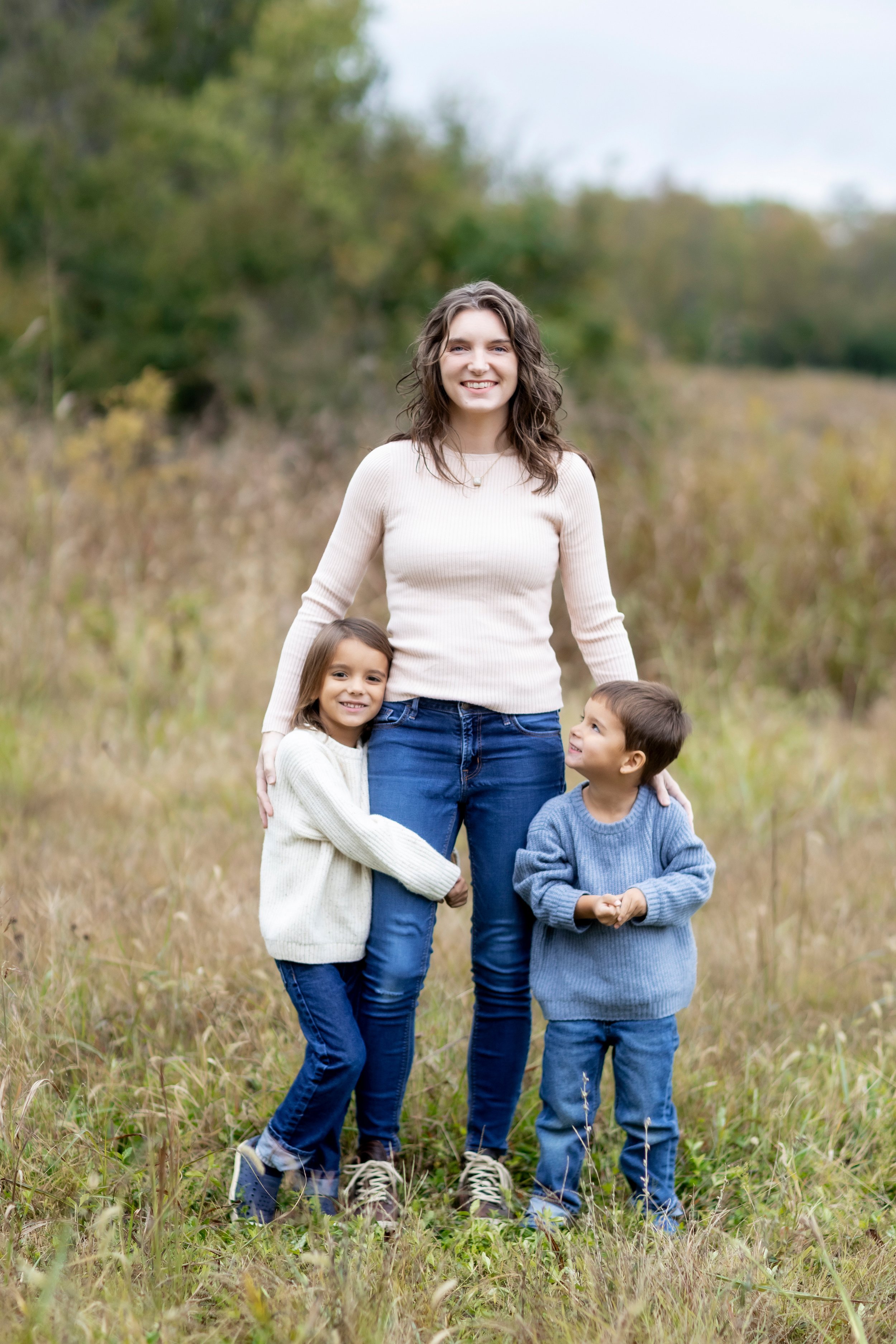 Chelsea Kirk standing with her two sons