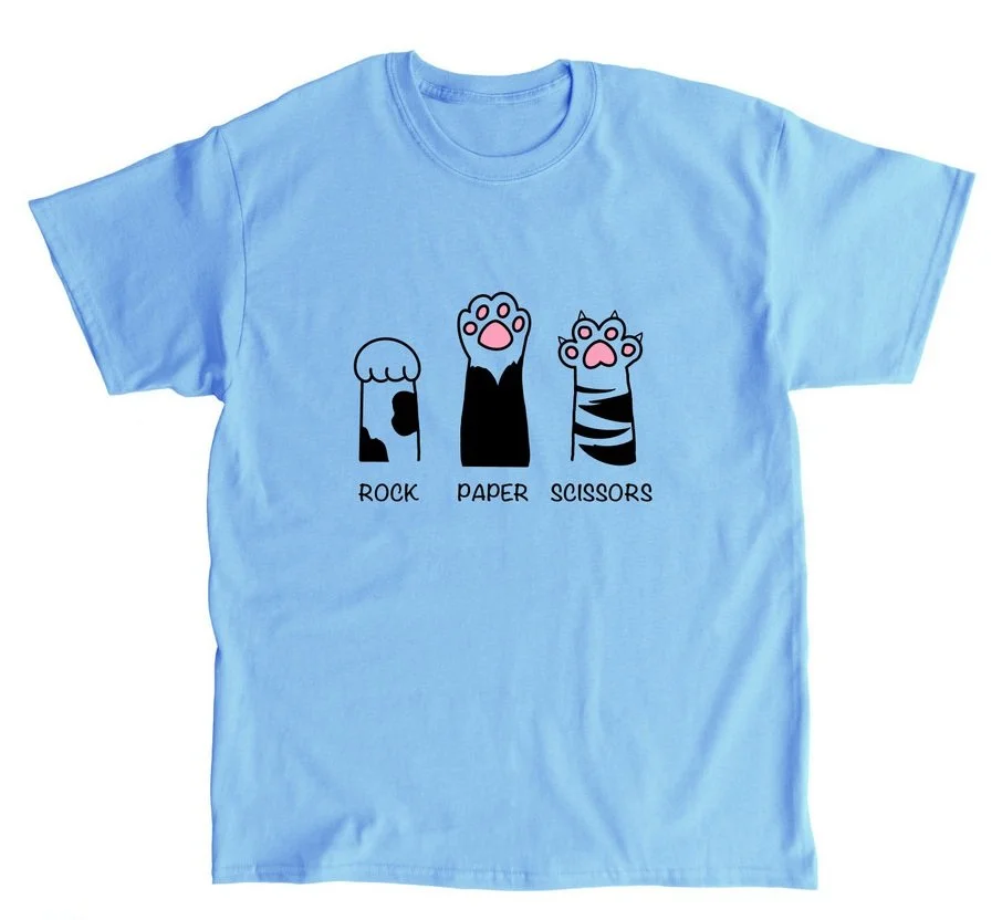 Light blue T-shirt with cartoon illustrations of a paw representing rock, a paw representing paper, and a paw representing scissors, each labeled accordingly.