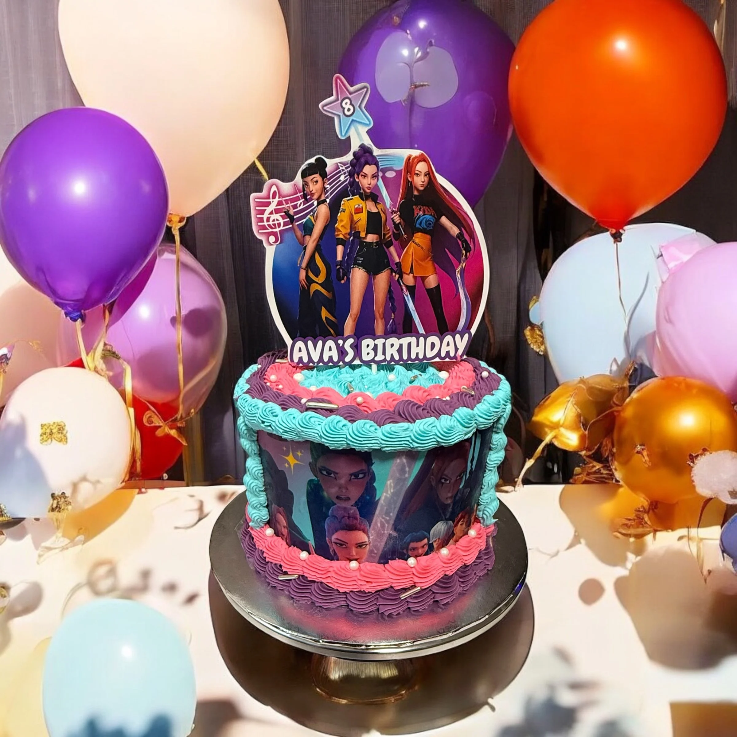 Colorful birthday cake decorated with 'Violet Evergarden' characters and a topper reading 'Ava's Birthday,' surrounded by balloons in purple, pink, white, gold, and orange.