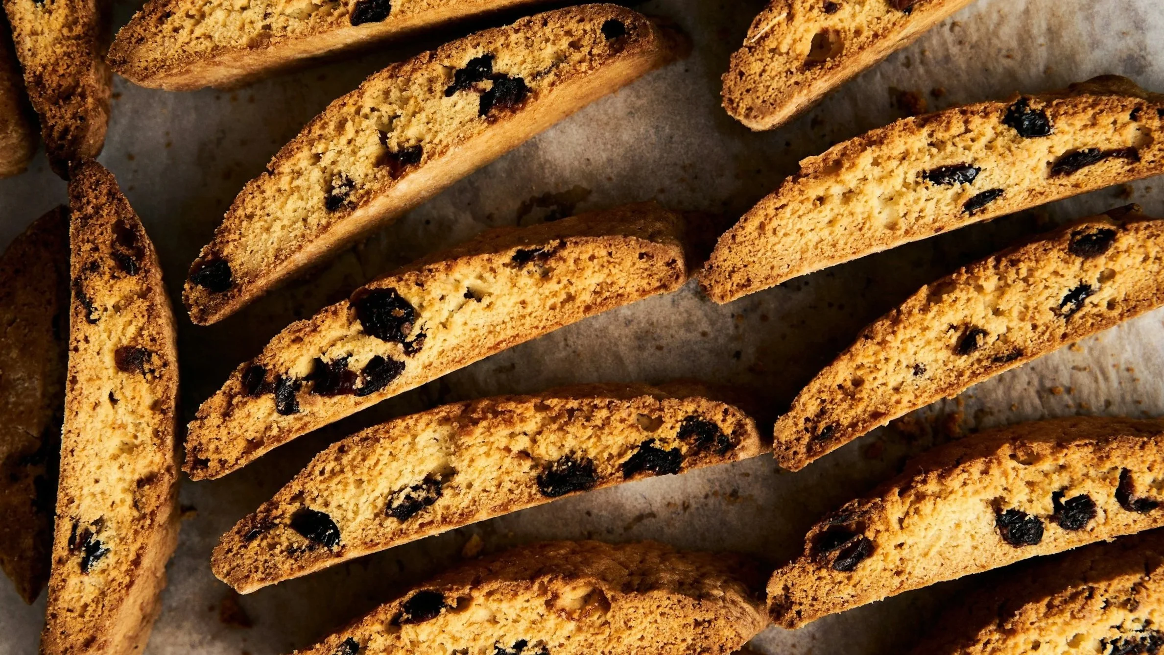 Close-up view of chocolate chip cookies sliced in half and arranged on a baking sheet.