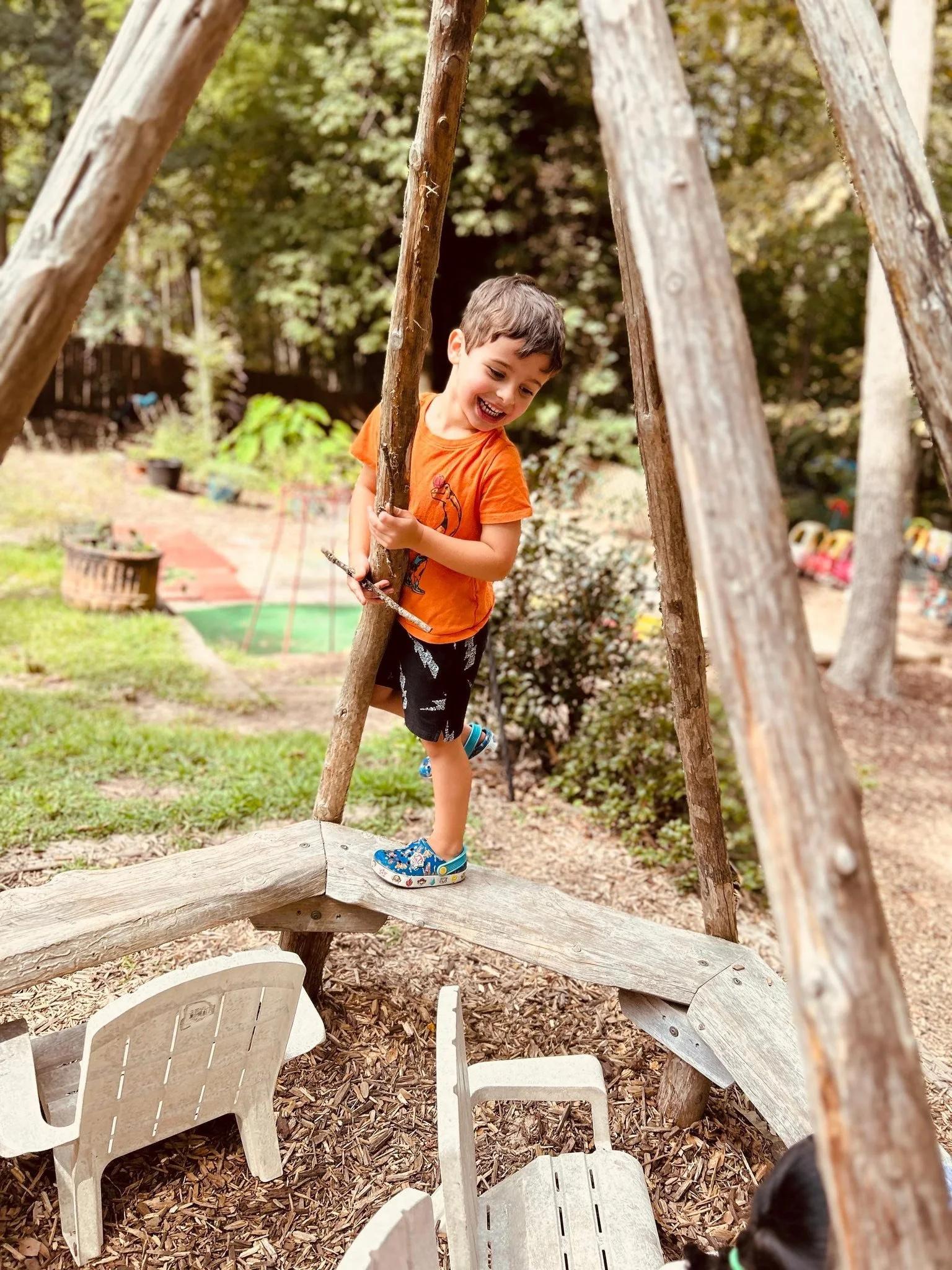 A preschooler climbing on playground equipment