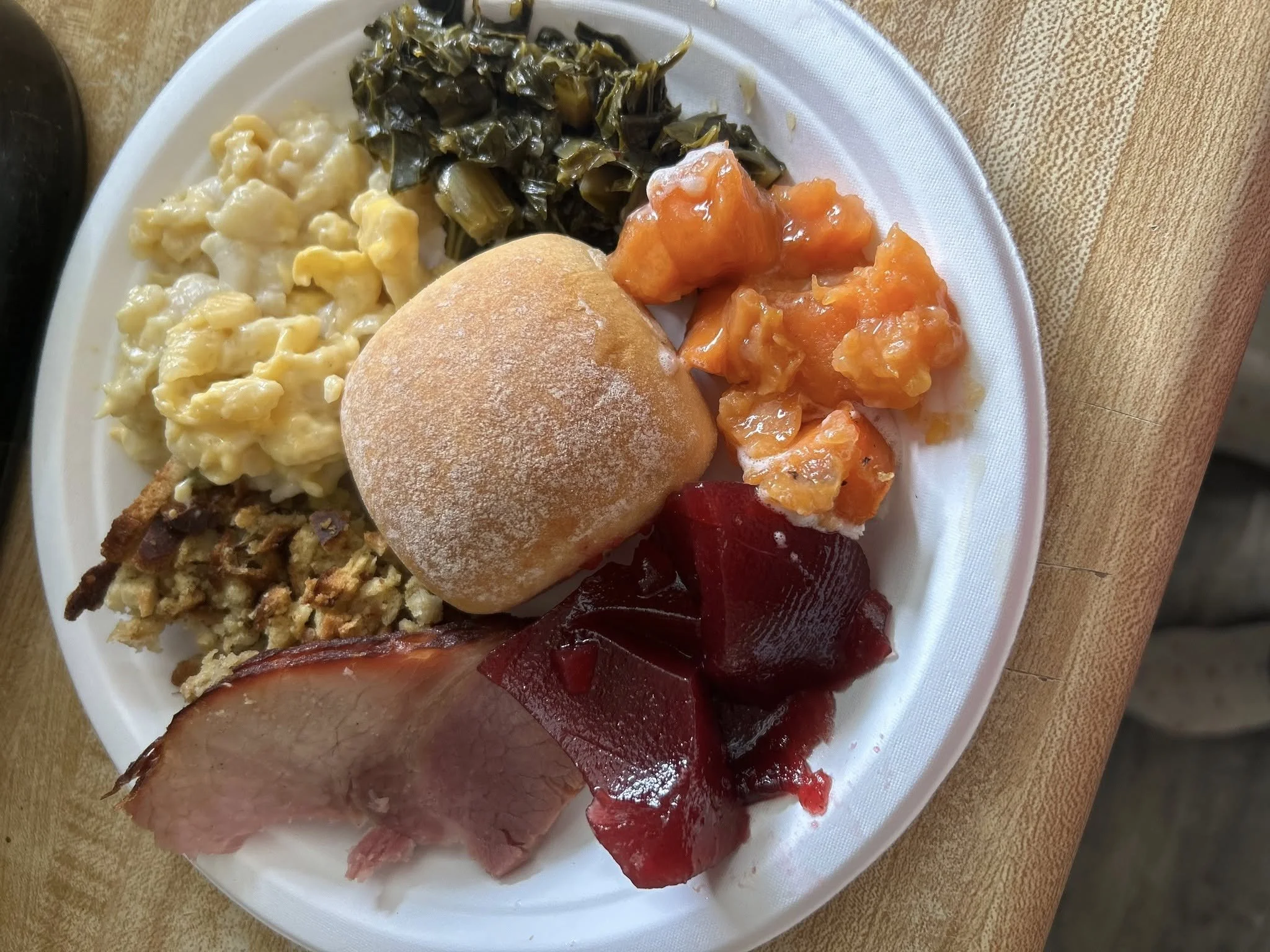 Baked ham, dressing, mac & cheese, cranberry sauce, baked carrots, collards, and a roll