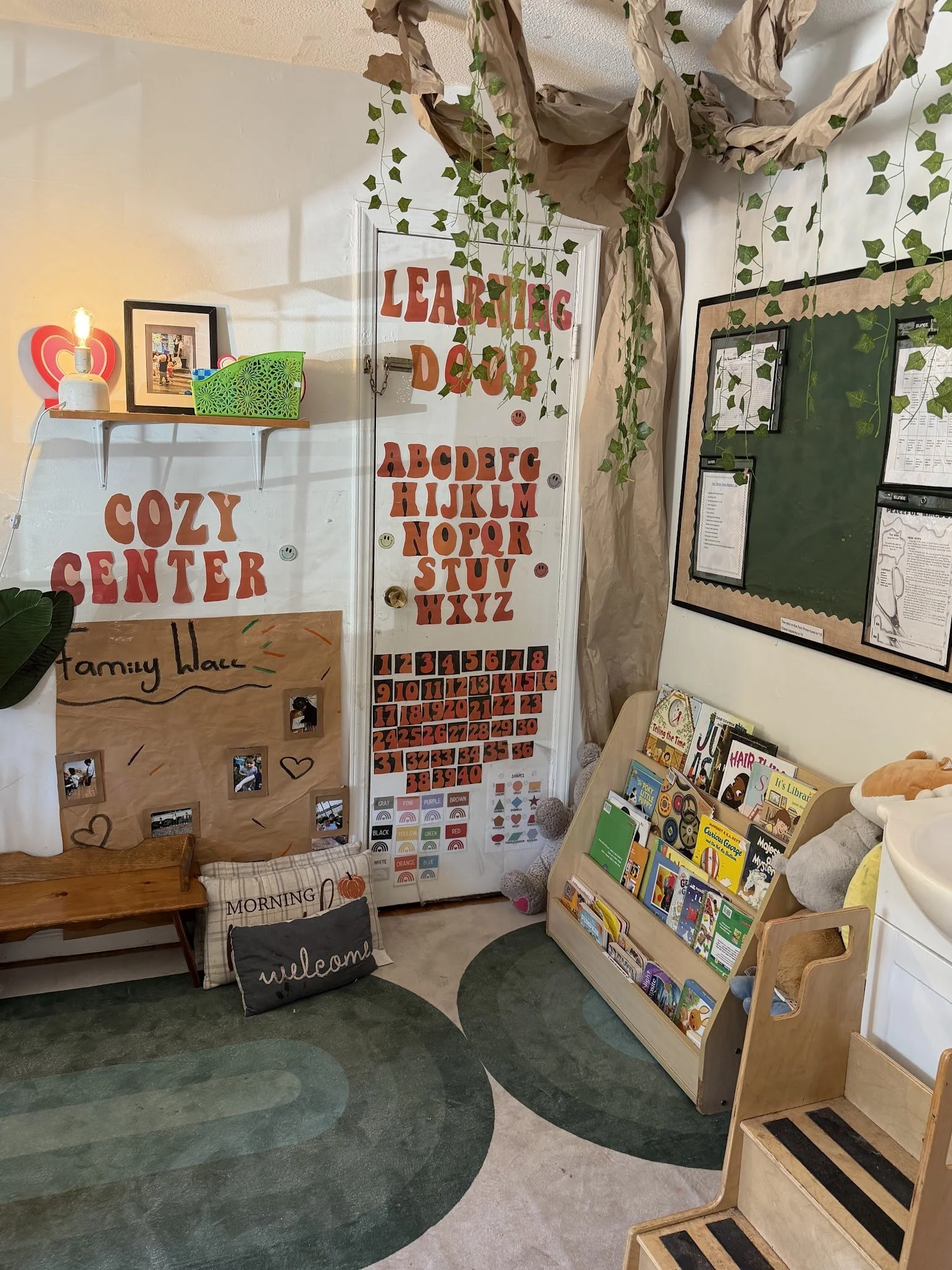 The cozy center and learning door with books pillows and other learning materials