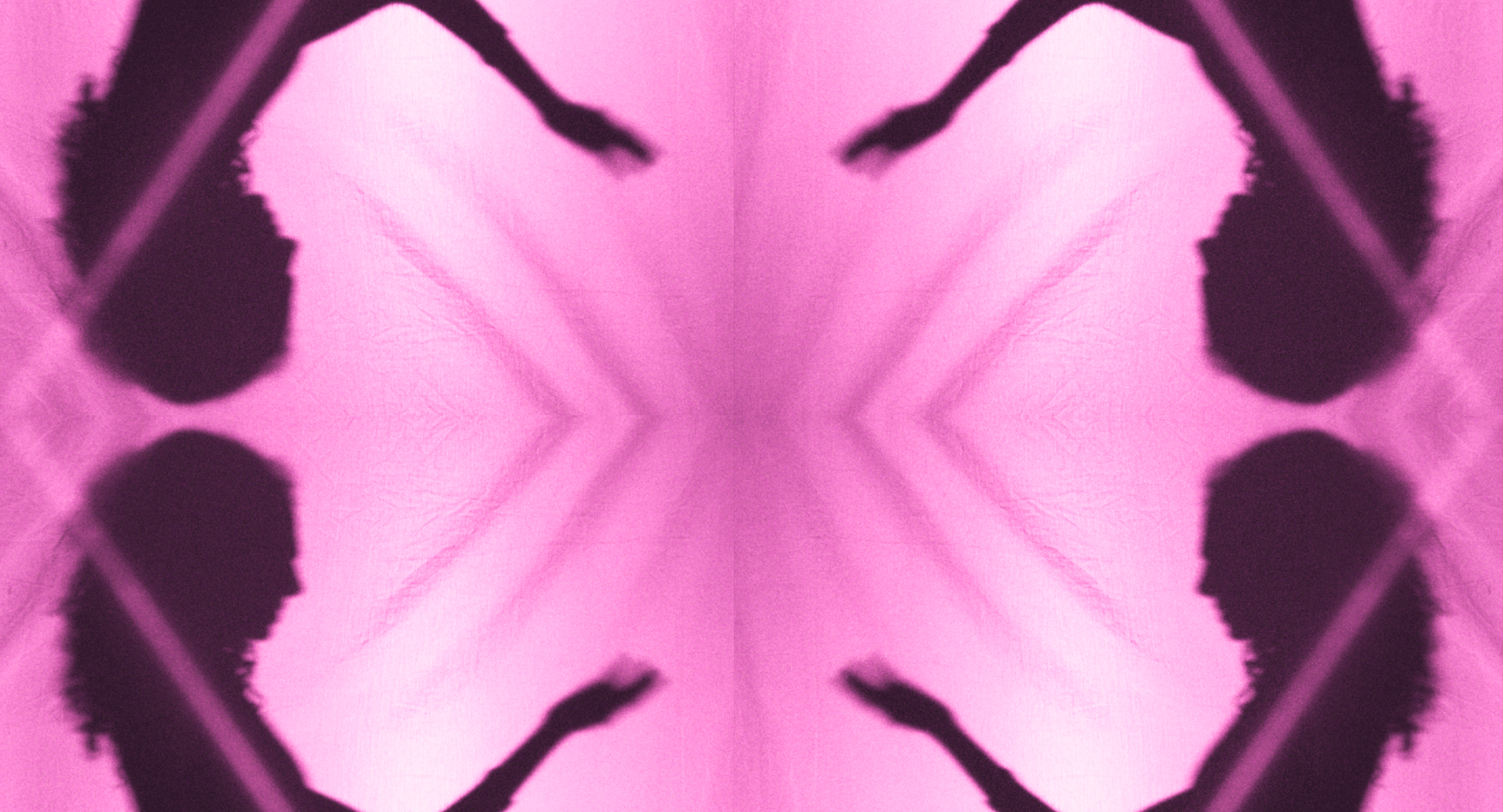 A symmetrical, abstract pattern in pink and black with shapes resembling butterfly wings or moths facing each other.