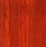 Close-up of a wooden surface with reddish-brown tones.
